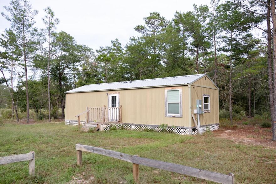 Discover tiny home living at its finest! This charming 1 or 2 bedroom cottage proves that good things do come in small packages. Thoughtfully designed for efficiency and comfort, it features a modern mini-split A/C system, a tankless water heater, and cozy front and back porches perfect for morning coffee or evening sunsets. Nestled on a 1/4-acre lot, you'll have just enough space for a garden, firepit, or hammock, without the hassle of endless yard work. Enjoy the peace and quiet of country life while being just a quick drive from the powder-white sand beaches of the Emerald Coast. Whether you're looking for a smart rental investment, a minimalist retreat, or a starter home that won't break the bank, this tiny treasure checks all the boxes.Live simply. Live smart. Live small.