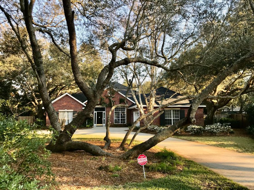 This beautiful brick home nestled in the trees on a quiet cul-de-sac in the heart of Destin is ready for you! The open floor plan with hard wood floors and high ceilings lends itself to a spacious feeling. A 4th room used currently as a workshop would be an exercise room, office or any other space. The appliances have been replaced over the last 2-3 years. Gas oven and cooktop helps to create gourmet meals. The Quartz countertops are both stunning and durable! Overlook your 3/4 acre lot with pool as you lounge on the large covered porch. The fenced yard is full of flowering plants that the owners have nurtured since building this home in 1994. There is a new roof and gas hot water heater (as well as Wired sound system) leaving nothing to do but move in