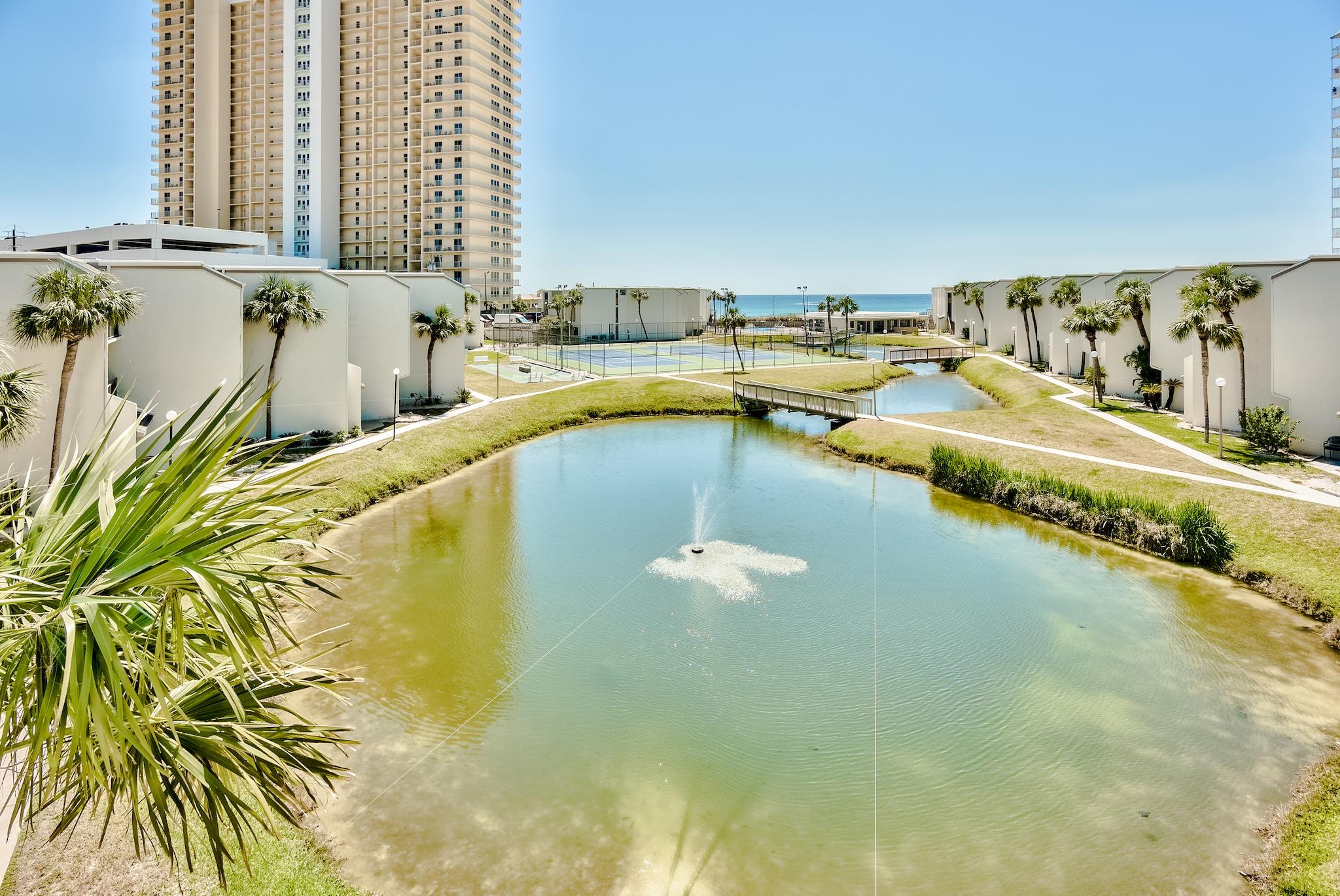Residing in Sugar Beach, one of Panama City Beach's most sought after low-density complexes, this three bedroom unit encompasses two levels of thoughtfully designed living space with over 1,500 square feet. Both floors feature spacious balconies overlooking the beach and lake views. The living and dining area open up to the kitchen with breakfast bar, granite countertops, updated appliances, and ample storage. One bedroom and full bathroom complete the first floor. Showered with natural light, the main suite on the second floor boasts direct balcony access, dual closets, and an ensuite with custom tiled shower. The amenity rich complex reigns over 300' of beach-frontage and is strategically located within close proximity to the world-class dining, shopping, and entertainment venues