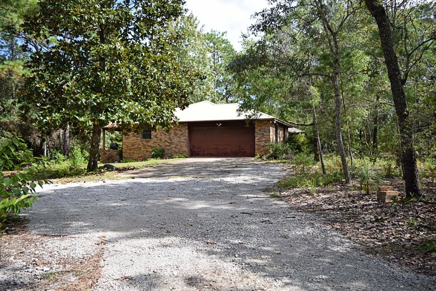 This well maintained home sits on a lovely full acre lot boasting mature trees. This serene setting has been left natural, providing a park like environment with no yard work required!This full brick home has large rooms with the 25 foot living room stealing the show with its huge brick mantel and fireplace. Bracketed by large windows on each side, the beautiful setting can be enjoyed even while inside. The large covered porch is a perfect place to enjoy an al fresco dinner or cocktails, and the two room workshop/mancave on the back of the property will be a handymans dream! All of this in a convenient location to the Bay bridge or Eglin makes this a great home for a growing family.