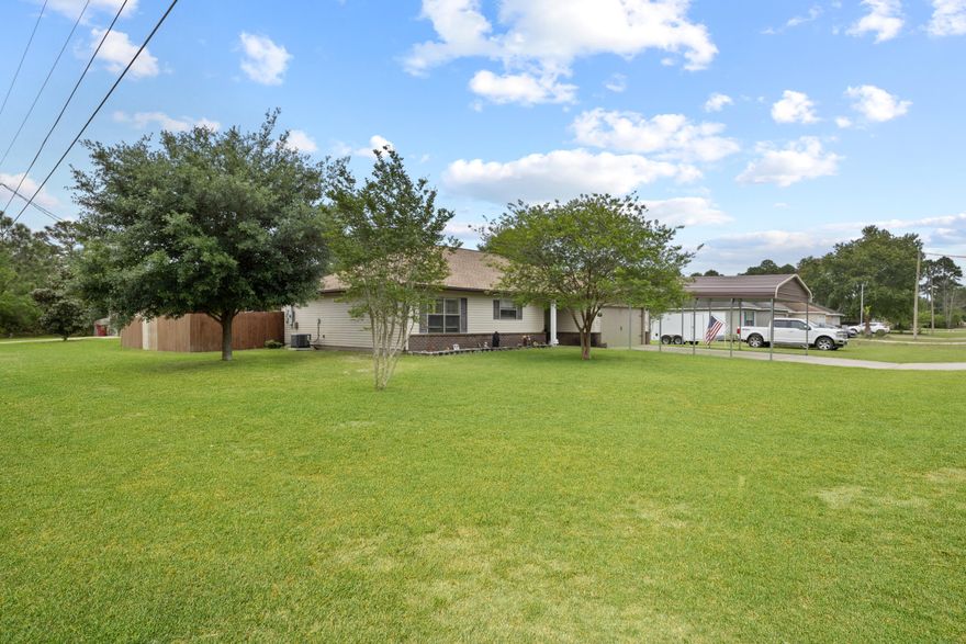 This Navarre home is situated on a large 1/3 acre corner lot, boasting impressive curb appeal. The house comes with several recent updates, including a new roof, A/C, water heater, gutters, covered porch and an adorable 10x16 shed. These updates make the home low-maintenance and insurance-friendly.One of the notable features of this home is that it is located in a no-flood zone and does not have any HOA, providing more freedom and flexibility for the homeowners. The house also comes equipped with hurricane fabric shutters, which help add to the insurance discounts. termite bond can also be transferred.Inside, the home features 10-foot ceilings without popcorn! The spacious kitchen with stainless steel appliances, a pantry, and ample room for adding a kitchen island.