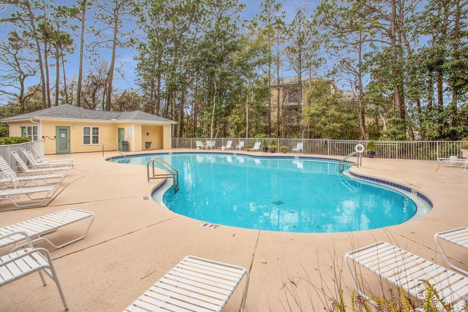 Like new ground level 2-bedroom, 2-bath condo. Stainless steel appliances & granite countertops. Spacious master with private ensuite bathroom. Covered balcony overlooking trees & greenery. All tile & wood look floors throughout. Separate laundry room. Community pool & gym. Just steps to all the shops of Grand Boulevard & minutes to the beach!