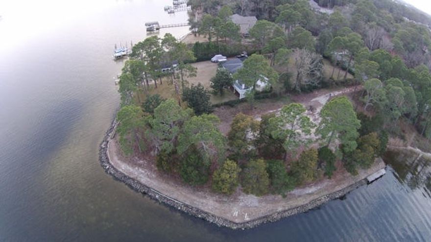 Prepare to be amazed by the views and opportunity this lot offers. An impressive 422.13 ft of deep protected water on Rocky Bayou!!! Build your dream home or divide lot and build 2 or 3 homes. There is a path that can be driven on or walked on, but old dock should not be walked on. Please use caution. Buyer to verify all information and dimensions of lot.