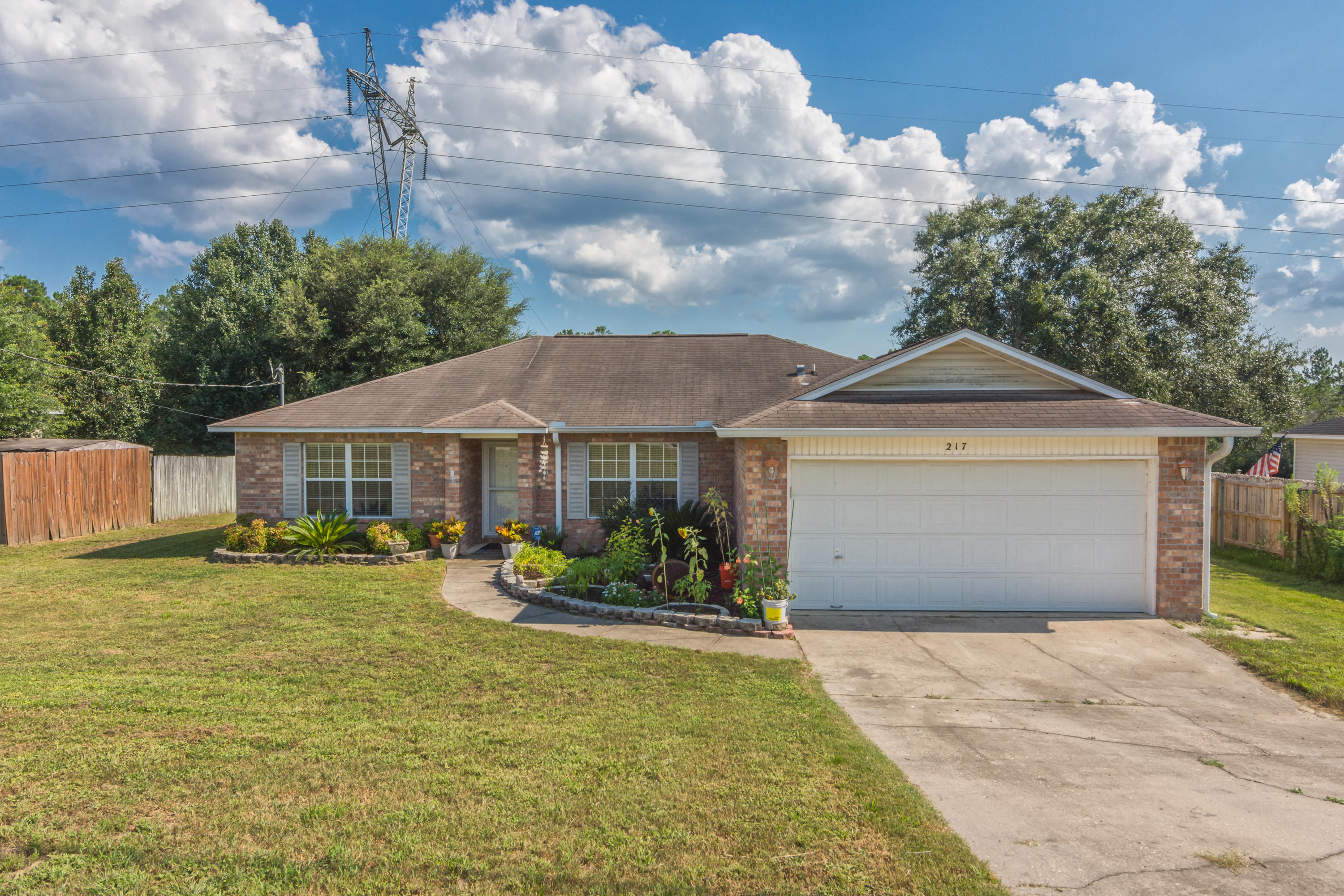 New roof with accepted offer! Looking for a South Crestview home nestled in a quiet neighborhood? This is it! This well maintained FOUR bedroom home features a split floor plan, large living room with vaulted ceilings, and a spacious eat-in kitchen plus hardwood and tile floors throughout common areas. The kitchen is a cook's delight with newer stainless steel appliances, large single basin composite sink, island with storage, and a ton of cabinets! The master bedroom and three additional bedrooms are nicely sized with the master bath featuring double vanities, walk-in closet, linen closet, and toilet room. Rounding out this home is the interior laundry room with cabinet space. Enjoy your morning coffee on a newly built deck made with composite boards, overlooking a nice wooded area.