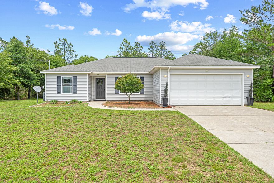 Sitting pretty on a spacious .8-acre corner lot, this 4-bedroom, 2-bath home at 59 Commerce Circle offers the kind of everyday comfort you'll appreciate the moment you walk in. Built in 2014, this one has been loved and looked after and it shows. You'll find vaulted ceilings and an open layout that gives the main living space an easy, airy feel. Natural light pours in through the east-facing windows each morning, setting the tone for peaceful coffee time. The kitchen is just right with granite countertops, a stainless double sink, breakfast bar, and a closet pantry tucked away for extra storage.The primary suite is privately placed on its own side of the house and features a spacious bathroom with a garden tub, separate water closet, and plenty of room to unwind.