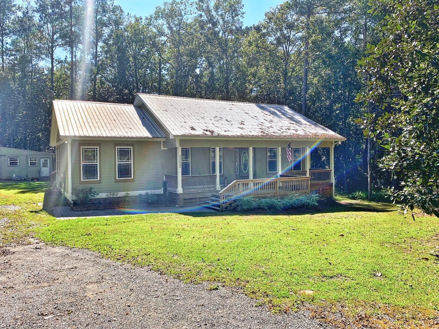 This beautiful custom built home is 3 bedroom 2 bath on 1 acre. The exterior features large covered front porch 32X8. When entering the home the first thing you will notice is the beautiful hardwood floors. The living area has cathedral ceilings with a wood burning fireplace. The living area and kitchen are very open. The kitchen has plenty of cabinet space. The laundry room is located off of the kitchen with a back door to the 14X16 deck. The master bedroom is very spacious with master bath featuring double vanity sinks, large whirl pool tub, separate shower and his and her closets. This home is very private. All measurements must be verified by buyer. Schedule your showing today!