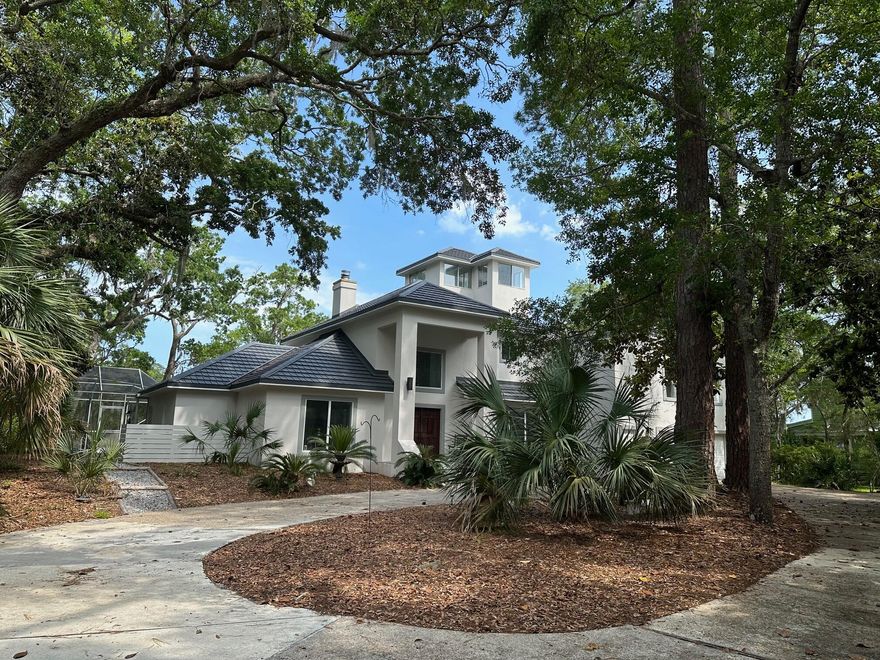 AMAZING VALUE!! JUST REDUCED $145K + PLUS $58K NEW Metal Tile Roof 2025!!!!! BELOW MARKET FOR LOT SIZE AND SQ. FOOTAGE. Waterfront privacy with RARE 1-ACRE containing 167' bay/bayou waterfront.  Enjoy sun rises while dolphin, deer & osprey entertain. MAIN HOUSE 1ST FLOOR: Master bedroom suite// Formal Livingroom (convertible to bedroom)// Formal dining (convertible to office)// Soaring Great Room// Large eat-in Kitchen// Large laundry room. LOVELY FOYER STAIRCASE leads to 2ND FLOOR: Master Suite. 3RD FLOOR: Viewing Tower. MAIN HOUSE has two large master bedroom suites. THIRD BEDROOM is located in the APARTMENT above the attached garage which also contains living/dining/kitchen combo & full bath.