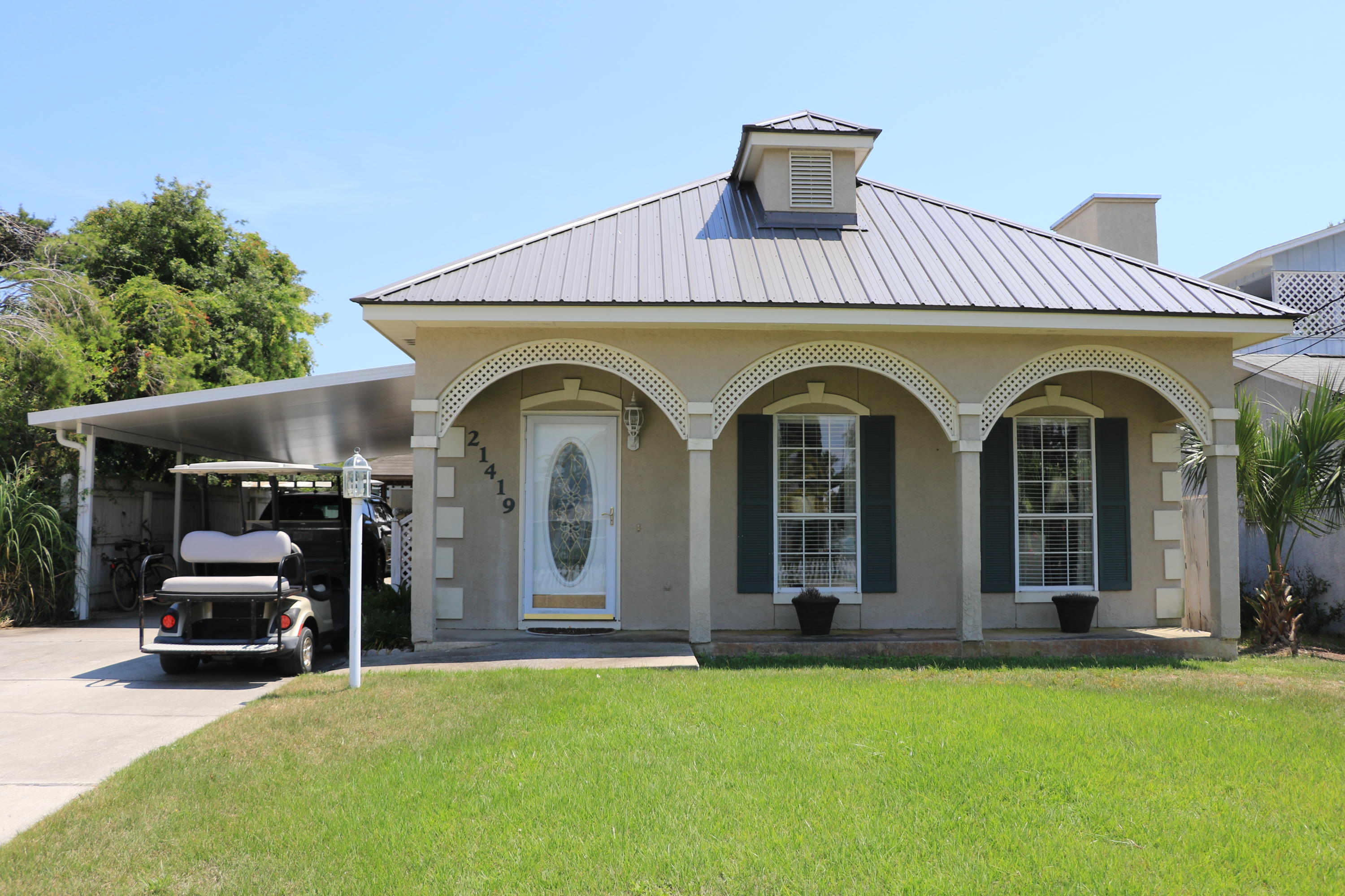 Beautiful beach home just a few short blocks from the beach. This home is on the West end of Panama City Beach and has many wonderful features: master + 2nd bedroom downstairs, 3rd bedroom + loft/bonus room upstairs. Large family room and dining room (open plan). One car attached covered carport. Screened in porch, fenced in back patio area, very quiet and peaceful. Storage building. All tile floors downstairs, carpet up. Covered grilling area / gazebo. Updated a few years ago: new paint, light fixtures, a/c only 5 yrs. old, landscaped backyard, metal roof only 5 yrs. old. Insulated carport only 1 year old.
