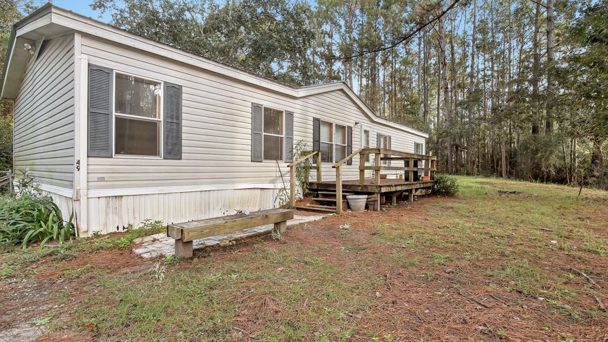 3 bedroom 2 bath Mobile home on half an acre! New metal roof put on in January of 2020 as well as the septic tank drain field. This home is being sold As-Is and as a fixer upper. This home is very close to the Shops at Publix Freeport. As outlined in the pictures, community has a dock on Black Creek.  Cash sale only.