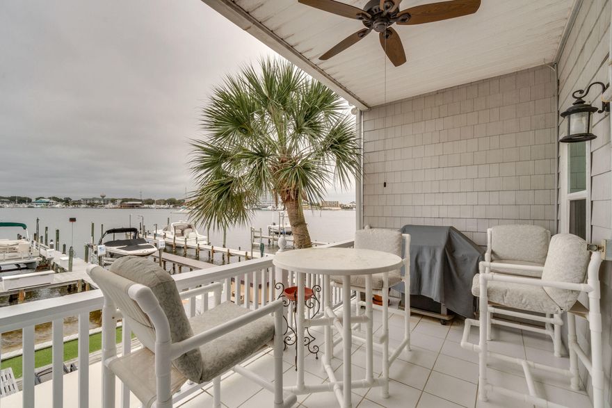 Magnificent, Remodeled Town-home on Holiday Isle with amazing Harbor Views from every floor. Walk out to the harbor to an amazing outdoor entertaining area with bar, retractable awning just steps away from your dock and boat. This town home features a huge renovated kitchen, large pantry, travertine/hardwood flooring throughout large living room and dining room area plus a covered porch overlooking the Harbor, Two Bedroom suites & Laundry closet are on the 3rd level with Spectacular Sprawling views of the Harbor from the Master Bedroom. Master Bedroom has a large double entry walk-thru closet. The heat pump is 2 years old, new garage door opener. Home has a 50 year Roof Warranty with 31 years remaining. Boatslip is 12' X 60' long and has a lift. MUST SEE for boaters.