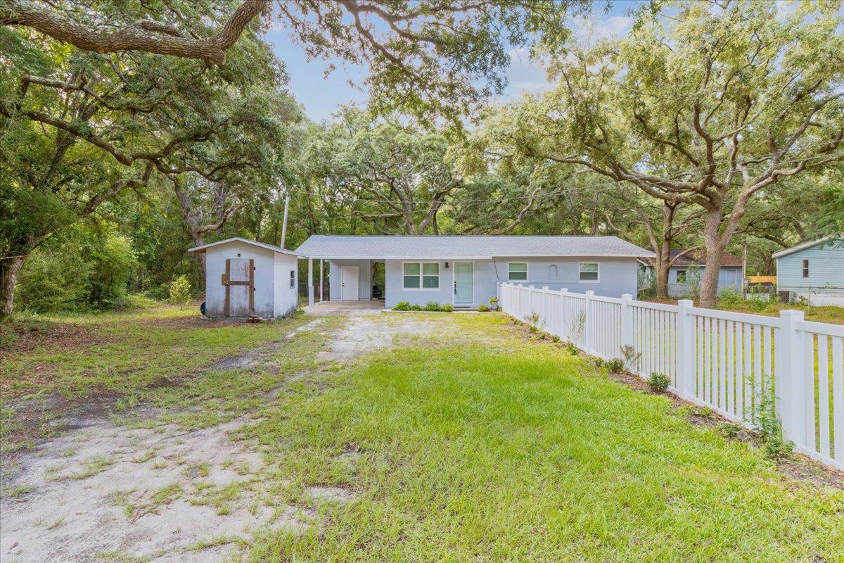 This home is located on a canal feeding into Mallet Bayou and out to the Bay. This adorable country 3 bedroom, 2 bath home offers the tranquility you've been searching for! As you enter the home, you'll be greeted by an abundance of natural light and a cozy living space. The kitchen has been beautifully updated with new cabinetry, stainless steel appliances, and butcher block countertops. The master bedroom offers plenty of space, a large closet, and en-suite bathroom.The oversized carport includes a separate storage area. The back yard offers large oak trees, a tranquil view of the water, and a small boat slip.Electrical re-wire, new roof, new windows, and new HVAC installed within the last 3 years.Easy access to the beaches on 30A, Destin,