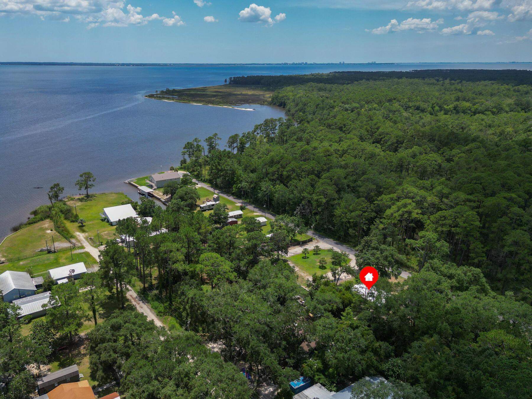 Old Florida at its best! This relaxing waterfront cottage, located in an X Flood zone sits on 2 lots with 120 ft. of canal waterfront. The canal leads directly to Alaqua Bayou then to the Bay. Upgrades include windows, water heater, roof, septic tank, drain field and ac unit. 2025 upgrades new flooring, exterior doors and dock replaced. Have the privacy of being close to the Bay, Eglin AFB, and convenience of being less than 5 minutes to two boat launches, Horsepower Pavilion and Dollar General. Less than 10 minutes to Publix. Plenty of room on the lot for Kayak, paddle board, boat and RV storage. Enjoy the beauty of pristine nature at its best. Grab your paddle board or boat and step back in time exploring the many unspoiled coves and creeks of this Old Florida paradise!