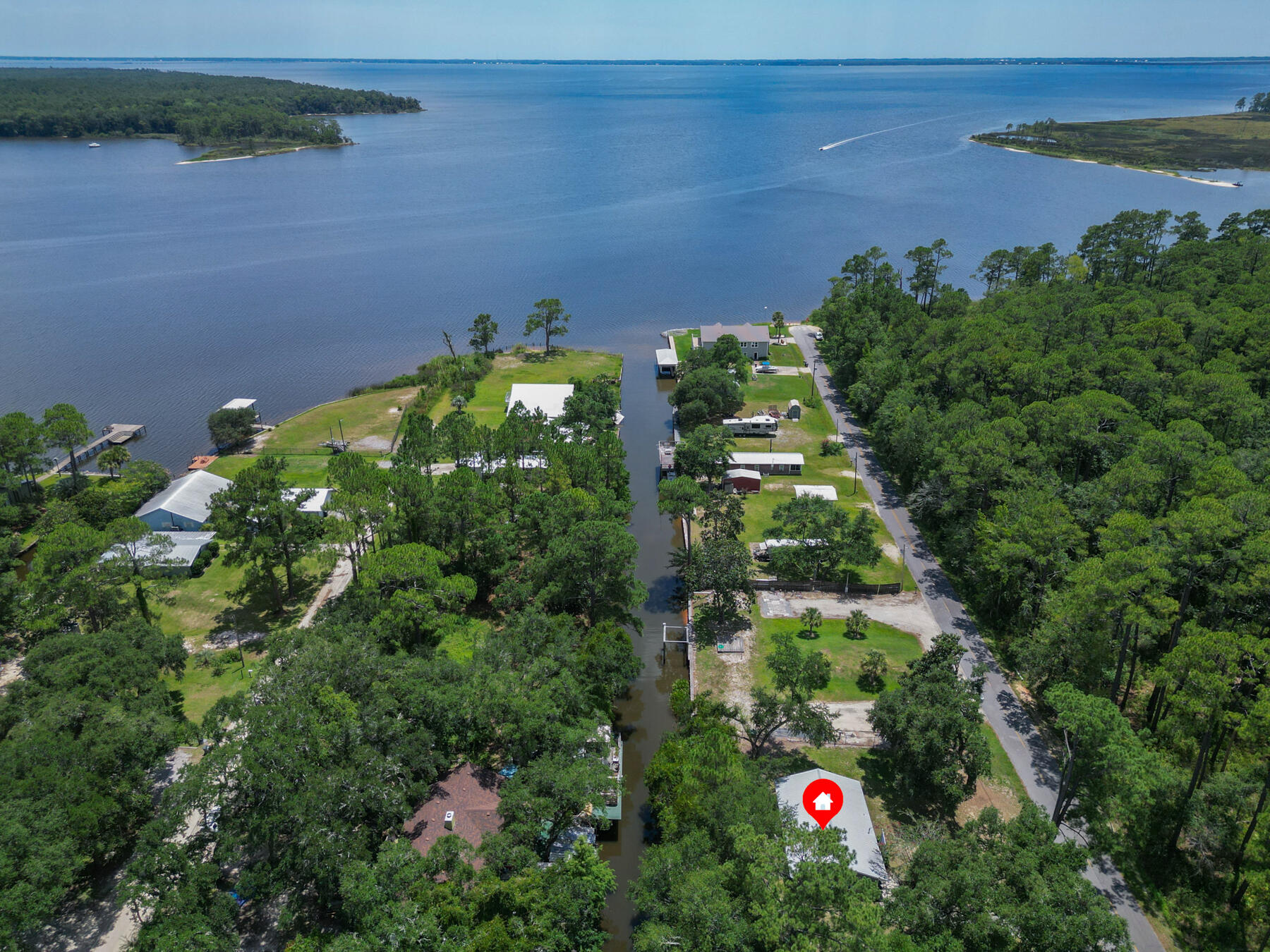 Old Florida at its best! This relaxing waterfront cottage, located in an X Flood zone sits on 2 lots with 120 ft. of canal waterfront. The canal leads directly to Alaqua Bayou then to the Bay. Upgrades include windows, water heater, roof, septic tank, drain field and ac unit. 2025 upgrades new flooring, exterior doors and dock replaced. Have the privacy of being close to the Bay, Eglin AFB, and convenience of being less than 5 minutes to two boat launches, Horsepower Pavilion and Dollar General. Less than 10 minutes to Publix. Plenty of room on the lot for Kayak, paddle board, boat and RV storage. Enjoy the beauty of pristine nature at its best. Grab your paddle board or boat and step back in time exploring the many unspoiled coves and creeks of this Old Florida paradise!
