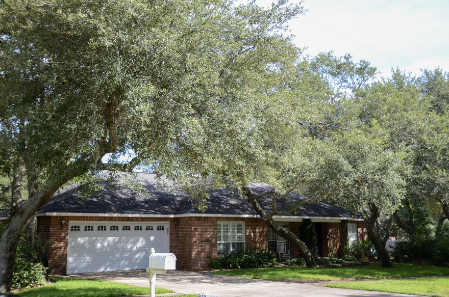 This freshly painted, beautiful brick home was custom built by Ray Hall on large corner lot in the heart of West Destin just a short walk to Destin Elementary School and right around the corner from Destin Little League Park.   The neighborhood is genuinely nice with lots of shade, large sidewalks going in both directions, and great neighbors.  This home has a lot of outstanding features including a vaulted ceiling in living room, split bedroom floor plan, trayed ceiling, tankless gas hot water heater, plantation shutters, dual fuel stove,  engineered hardwood floors, plantation shutters, crown molding, fiberglass doors, upgraded garage door, comfortable covered porch, privacy fenced backyard, sprinkler system with automatic timer, and lots of other extras.   See More... The extra-large washer and dryer are electric and only about a year old, but a gas line has been run for the dryer to operate on gas, as well. It features a Bosch dishwasher and an LG refrigerator, and the HVAC is less than 5 years old.  This is a quality home that has been well-maintained throughout its existence.   Seller has arranged for it to be shown anytime.