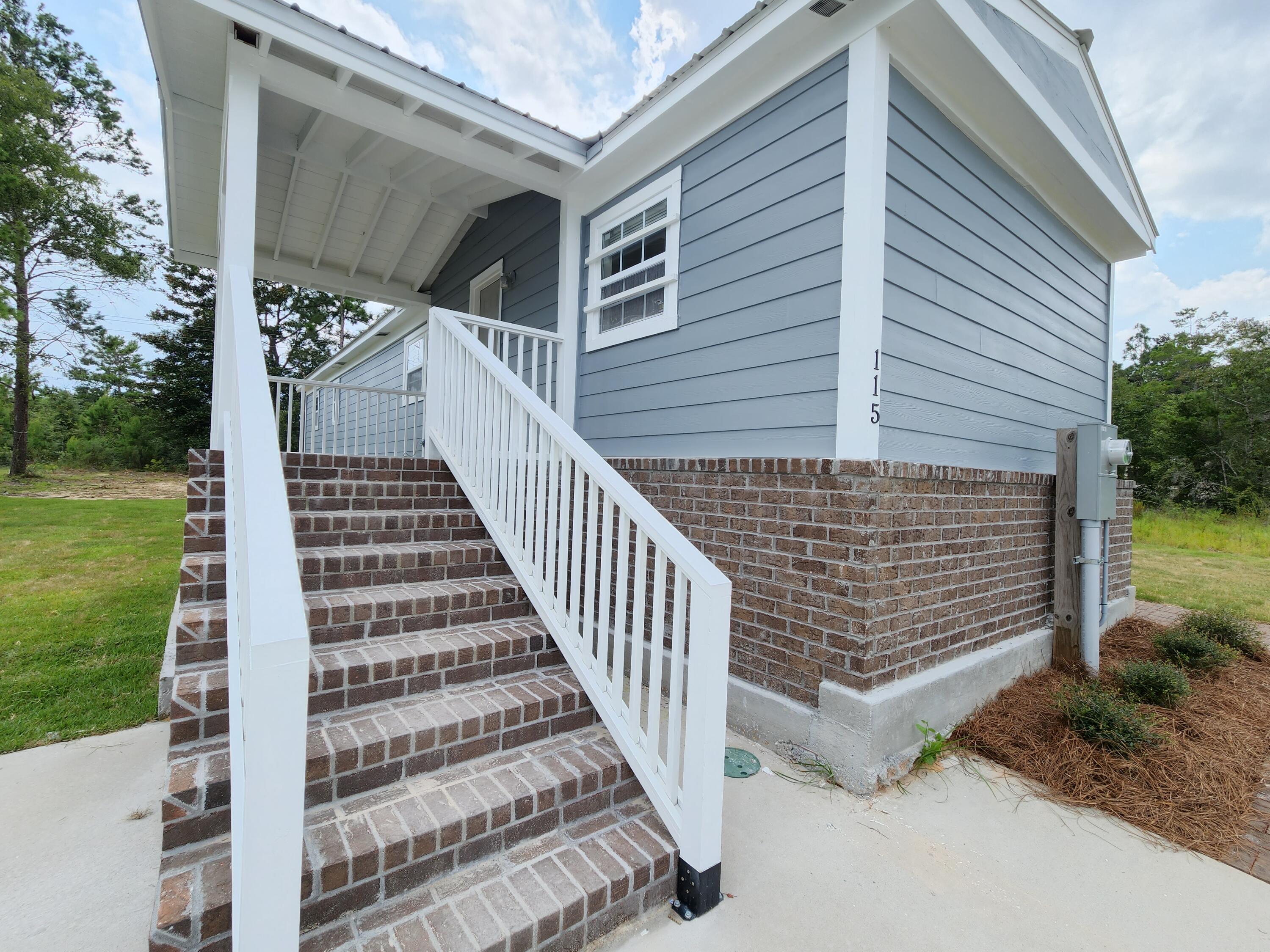 Just simply a lovely place to call home!!! This Completely Remodeled 3 Bedroom/2.5 Bath, 1,192 sqft, mobile home beautifully trimmed out with brick and hardy board siding sits on a large approx. 1/3 acre property in DeFuniak Springs FL. No HOA. (Almost finished construction and ready to move in!!) From the moment you drive up you are greeted with a large concrete driveway, brick sidewalk and crafted wood front porch all on spacious yard with plenty of room to roam & add a pool!! As you walk into the front door, you will enter a spacious open-concept kitchen and living area offering plenty of space to relax. Kitchen has lots of beautiful new cabinetry with new appliances (Stove/Refrigerator to be installed). A primary bedroom and bathroom was added on offering modern finishes and extra