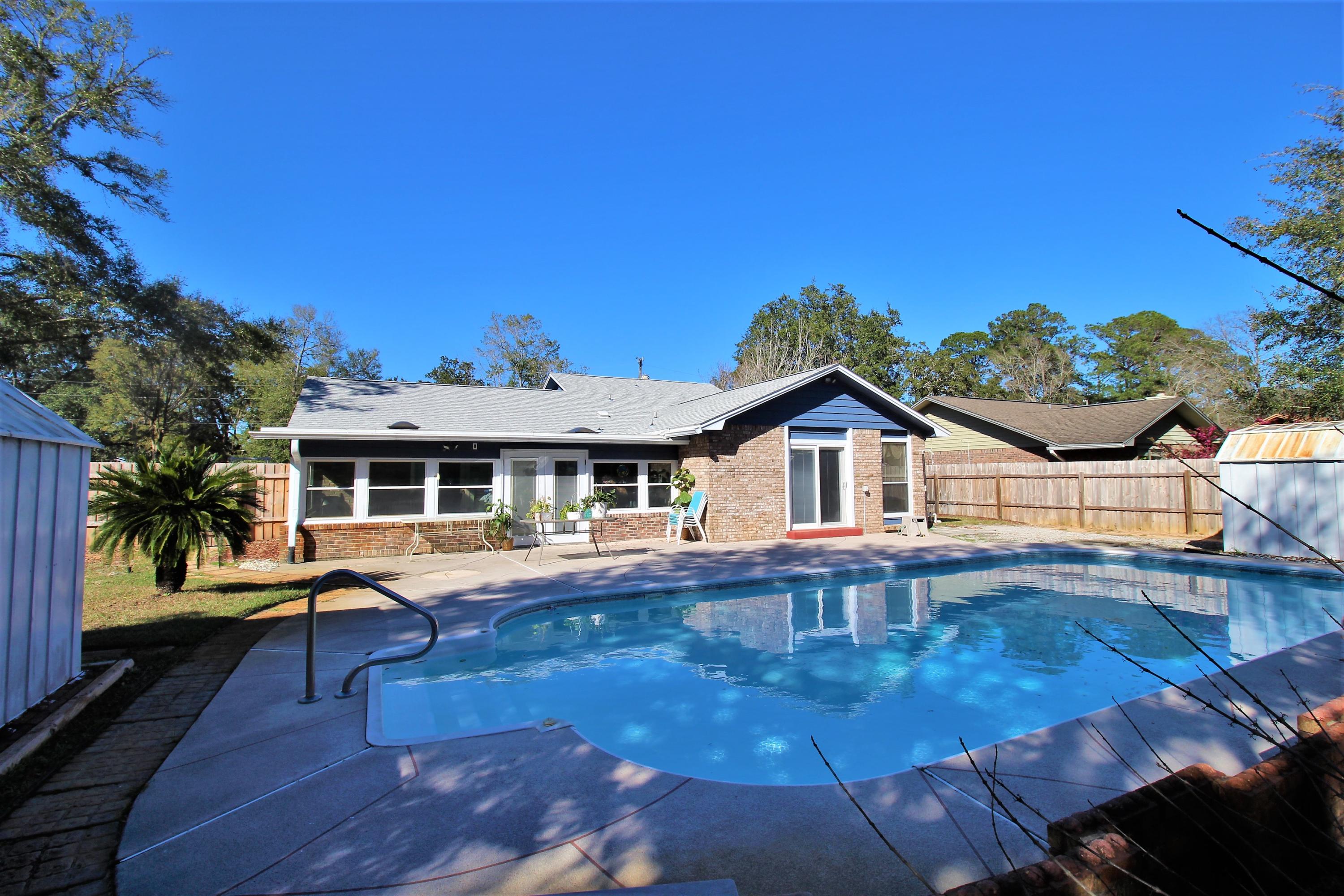 YOU FOUND IT! This well maintained and updated home has it all - EVEN A POOL! Inside, the kitchen flaunts new ceiling-height cabinetry, granite, stainless steel appliances, and ceramic tile flooring. The main living areas have new windows, new flooring, and a gas fireplace. The bathrooms are both remodeled with a jet tub in the hall bath and walk-in tile shower in the master. Access your POOL from the beautiful master bedroom's French doors or through the heated/cooled Florida Room. BUT WAIT! THERE'S MORE! New roof and skylights in 2019. Gas tankless water heater. HVAC 2017. 2 yard buildings (1 with power). Home is wired for emergency power transfer for use with a generator. AND a lush, landscaped corner lot, a stones throw from the neighborhood boat launch! *all measurements approximate