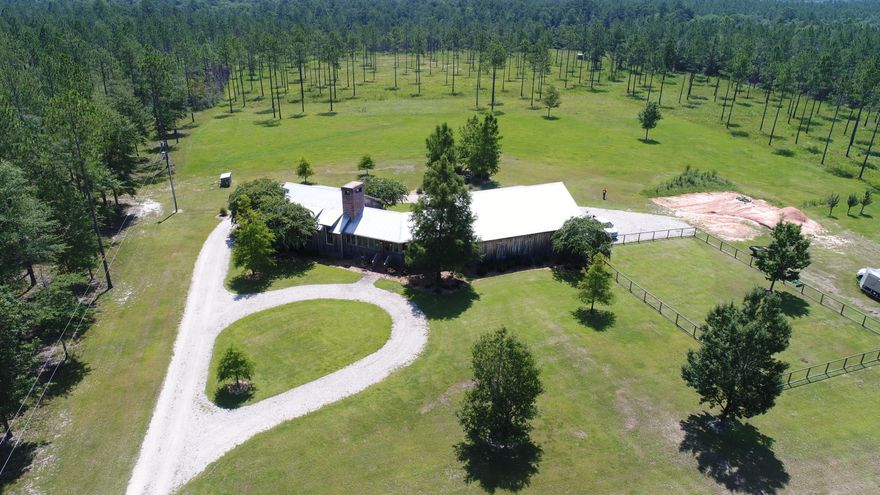 Motivated seller of a private woodland getaway with every luxury and comfort imaginable, your dream has just come true.
This beautiful home, three-car-garage, and surrounding acreage have been designed to the detail with unique rustic touches and technological upgrades throughout. The nearly 2,500-square-foot home is paneled with rough-cut cypress that is not only beautiful, but also hardy enough to provide shelter for generations. The interior also includes reclaimed 125-year-old brick as well as wood and beams from a 150-year-old North Carolina tobacco barn. Alongside the historical touches are modern amenities such as Yamaha receivers, three Sony state-of-the-art TVs, Control4 Smart Home automation, speakers to pipe music throughout the home, garage, and outdoors, and high-resolution Luna security cameras. Even though you will be in the country, you will not lose touch with the outside world thanks to the cell phone booster and high-speed internet through Exede. A Culligan reverse-osmosis water filtration system rounds out the modern luxuries.

Not only is the interior designed for everyday enjoyment, but you will enjoy every moment spent out of doors here on the 200-acre plot. Although situated within Walton Plantation with access to the community fishing pond, shooting range, and thousands of acres of horse and ATV trails, this home and its acreage are a secluded refuge complete with private entrance off Highway 2. The land has been designed and maintained with the nature enthusiast in mind. Strategically placed food plots, supplemental feeding, and forest managementincluding the planting of sawtooth oaksmake this an attractive area for deer and turkey. Nearby Long Creek also draws wildlife to the property.

This is the perfect place to "get away from it all" within 30 minutes of civilization. From here, you're an easy ride to restaurants, shopping, and groceries in Crestview or Florala and just one hour to the white-sand beaches of South Walton or Destin.

PROPERTY IS UNDER VIDEO AND AUDIO SURVEILLANCE.