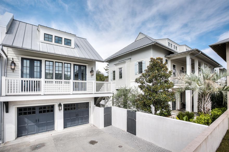 The outstanding location of this Rosemary Beach home which faces a pedestrian boardwalk leading to the beach, south of Scenic Highway 30A, is enhanced by its recently reinvigorated interiors, made especially bright and inviting after painting the bead board ceilings that carry throughout the second floor living areas as well as its custom hardwood kitchen cabinets, accentuated by a classic, white subway tile back splash. Its hardwood floors have been enriched with a darker stain to contrast with the new, lighter elements, seamlessly marrying them with existing, 150 year old rustic wood columns and ceiling beams that both support and appoint the 12-foot tall ceilings. In the evening hours, gas lanterns mark the entrance to the walled courtyard with their flickering light.