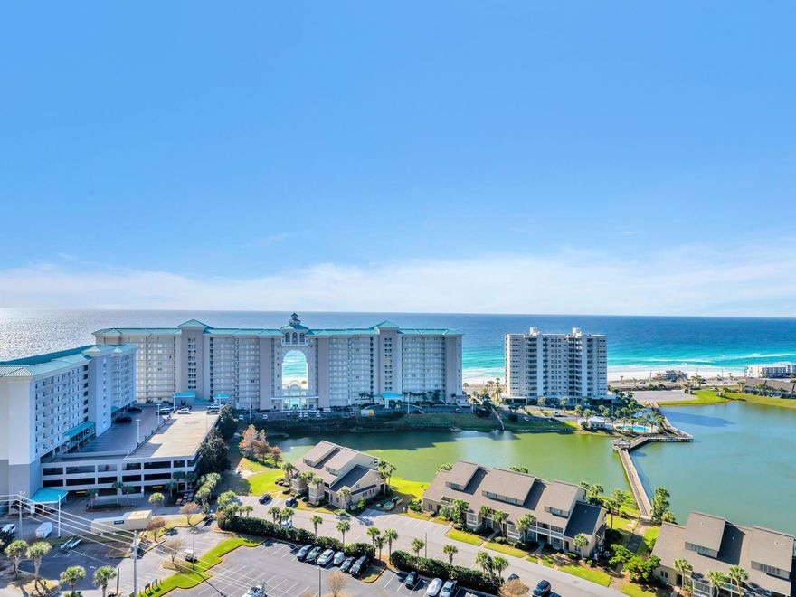 Gulf VEWS, Bay VIEWS, Lake VIEWS and Golf Course VIEWS.  This 3 BR, spacious, end unit is awe inspiring from virtually every room.  Southside patio is large enough for both a Dining and a Observation-seating area and a Northside patio that's the perfect tranquil hide-away.With more than 1700 sq ft, this condo will feel more like a house.  Updated, coastal-elegant decor creates a clean, contemporary feel that will be appreciated by all.  Phenomenal amenities including stunning lobby area, 5 swimming pools for owners, 3 swimming pools for renters, golf, tennis, fitness center, 4 elevators and an on-site restaurant w/ live entertainment.  Impressive Rental Projections!  HOA covers all utilities except electric