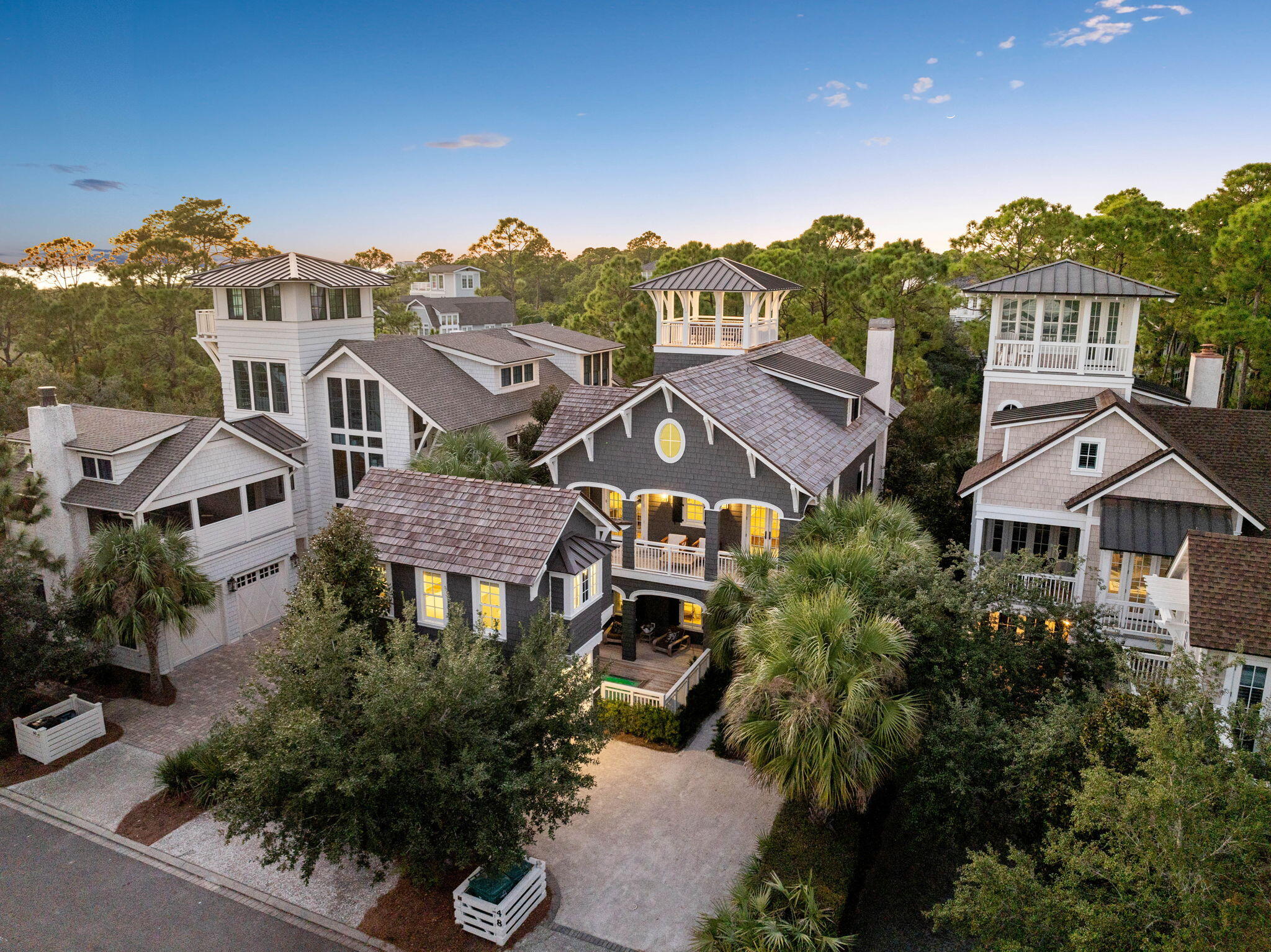 Nestled behind the private gates of Watersound Beach, 48 Shingle Lane is an exquisite coastal retreat, where luxury meets the natural beauty of Florida's 30A coast with exceptional proximity to private beach access and resort amenities in the heart of 30A. Thoughtfully designed with upscale amenities and curated interiors, this home features a main house, a charming carriage house, a private pool & easy beach access, and an elevated tower offering sweeping views of the Gulf of Mexico. On the first floor, the home welcomes you into a spacious living room with soaring 20'+ ceilings, comfortable seating, and calming views of the surrounding nature preserve. The designer kitchen boasts high-end appliances, ample storage, and an expansive center island with bar seating for four guests, making it an ideal setting for gatherings or quiet mornings. A stylish dining area offers seating for eight, leading to a serene screened-in porch yielding a cozy space to unwind. Additionally, this floor includes a sizable guest bedroom with a king-size bed and private bathroom with a walk-in shower, a convenient half bathroom, and a laundry room for added convenience. Outside, the private pool area, set at the front of the home, is complemented by comfortable seating, perfect for both sun-soaked afternoons and tranquil evenings.

On the second floor, an open media space offers a comfortable couch, a TV, and access to the front balcony, creating an inviting setting for relaxation. This floor also features a guest bedroom with two twin single beds, its own bathroom with a walk-in shower, and private access to the balcony. Additionally, a charming bunk room offers two custom-built twin-over-twin bunks and a private bathroom with a shower/tub combo, providing an ideal space for kids or additional guests.

The third floor serves as a luxurious escape with a master suite that includes a king-sized bed and an ensuite bathroom with dual vanities, a walk-in shower, and a soaking tub. A private balcony offers scenic views of Watersound Beach, while a quiet sitting area creates the perfect space for reading or relaxation. Ascending the spiral staircase, guests can access the tower, where stunning panoramic views of the Gulf of Mexico await.

For those seeking additional privacy, the carriage house offers a separate entrance and includes a king-size bed with its own bathroom featuring a walk-in shower, creating a secluded sanctuary. A private balcony offers beach breezes for cooler nights.

Centrally located within Watersound Beach, The Cottage on Shingle Lane is only 500 feet from the golf cart-accessible beach path and within walking distance to exemplary resort amenities including community pools, the Dunesider Grill, and the Hub/Big Chill for added dining and entertainment options. This remarkable vacation home combines elevated coastal luxury with privacy within a gated community, walkable access to a spectacular beach with arguably some of the prettiest dunes on 30a, all the comforts of home, promising an unparalleled experience along 30A.