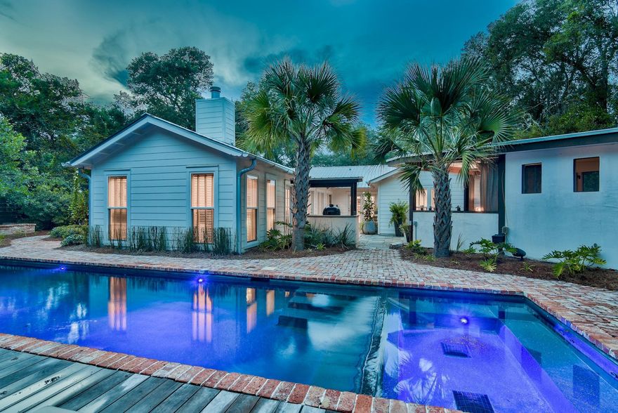 One of the most unique homes along 30A! Completely custom remodeled in 2016, the home features 120 year old reclaimed oak flooring and wallboard throughout. The open living area features a two sided fireplace that separates the living room from the reading room. French doors create a multitude of brightness and easy access to the fabulous outdoor space. A screened in porch that is constructed with reclaimed cypress wood on the walls and ceiling is the ideal place to curl up with a book. The outdoor patio features Pennsylvania slate that then leads to another outdoor pergola which also has it's very own wood burning brick fireplace. The backyard is highlighted by a phenomenal swimming pool with old Chicago brick and Brazilian Ipe decking and copper scuppers as a water feature. Glorious