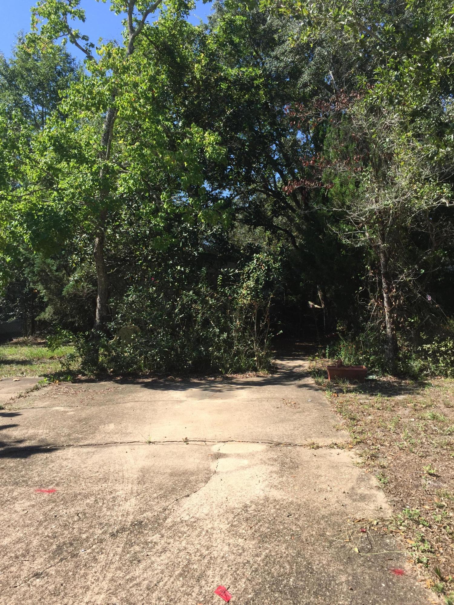 LAKEFRONT mobile home lot in the heart of Niceville, close to Eglin AFB and area beaches. Use of community pool and community building included in low annual HOA dues. BUT, UNINHABITABLE mobile home and 2 storage buildings sit on this overgrown property. Out of town owner inherited and never lived in or on the property. Great potential for a buyer willing and able to clear the land and remove the mobile home and storage buildings and contents of all 3.