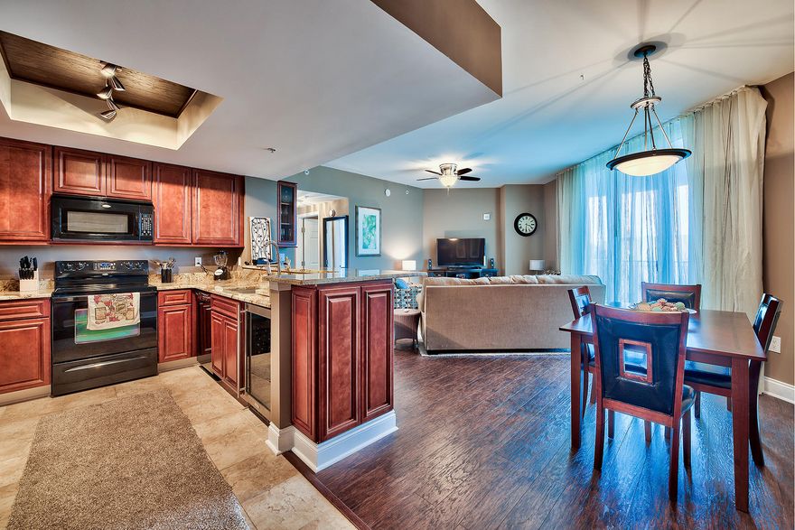 Custom finishes abound in this plush unit outfitted with contemporary features and beaming with character. Engineered hardwood floors are found throughout the main living areas including the living room, dining room and hallway as well as new max upgraded carpet in both bedrooms. The kitchen is finely appointed with custom cabinets featuring soft close doors & drawers, 3cm thick Italian granite countertops, 50+ bottle built in wine chiller, dry-bar, industrial stainless steel inset sink with color changing faucet and in-lay wood ceiling with modern lighting adding beautiful ascetic depth. There are two full bathrooms each featuring 36 tall vanities complete with granite countertops and modern clear vessel sinks. This exceptional unit is a great layout with 3 balconies.