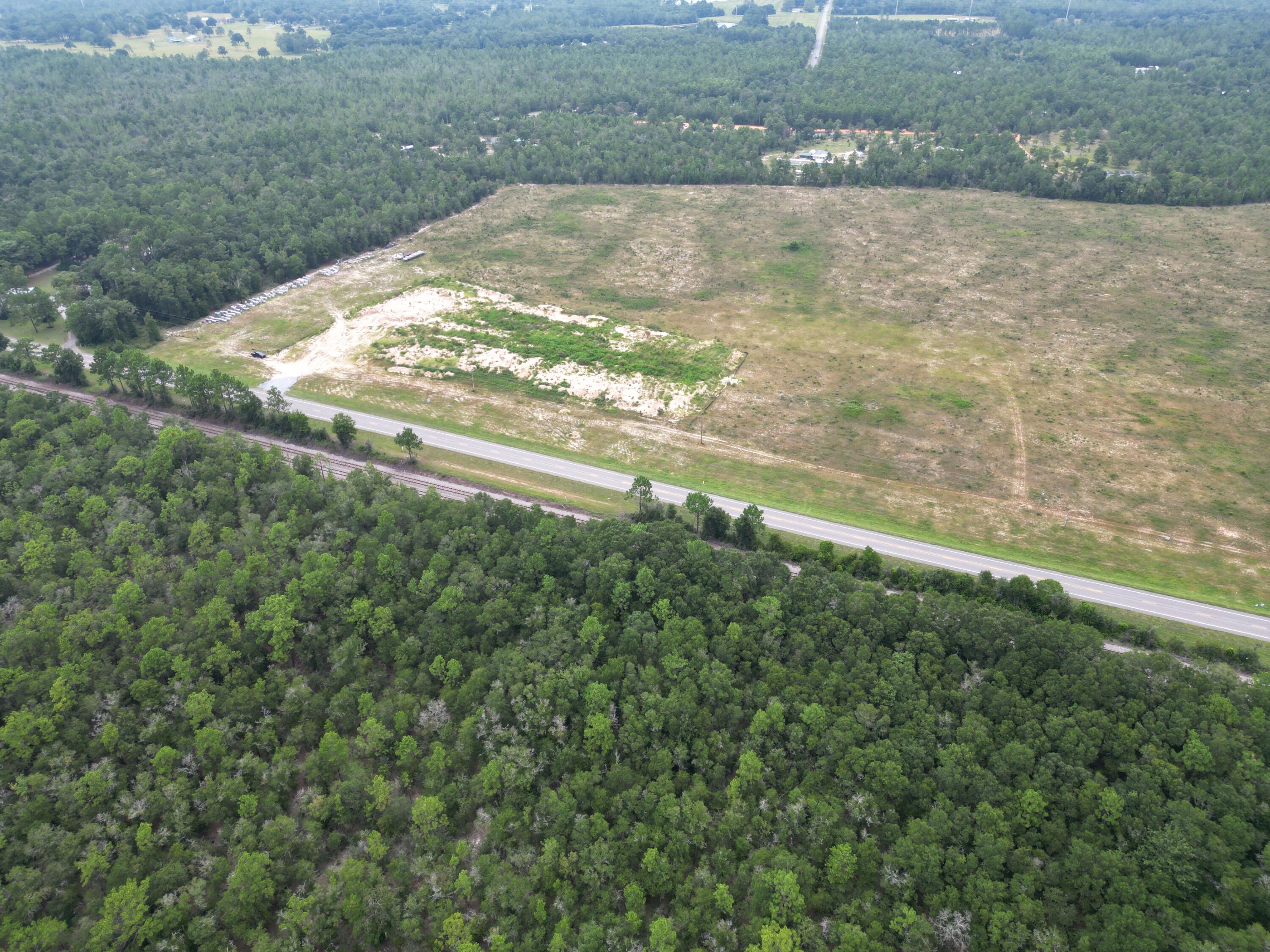 DEVELOPMENT ORDER IN HAND. This is an opportunity to purchase all 87 lots as paper lots. Option for purchasing all 87 finished / pad ready lots, see MLS 984869. There are 2 other options to purchase finished lots: 1 to 9 lots @ $72,500 per lot or in increments of 10 at $68K per lot. The proposed new development is 5 minutes west of DeFuniak Springs on Hwy 90, consisting of 87 detached single family residential homes on approx. 59.73 acres. Septic will be used / permitted for each lot. Public water. The development will have 2 driveway connections to Hwy 90. Zoned Rural Village, Flood Zone X. According to wetland study on the total 64.61 acres (study done before commercial property split), .35 acres is wetland, located on the eastern boundary of the lot.