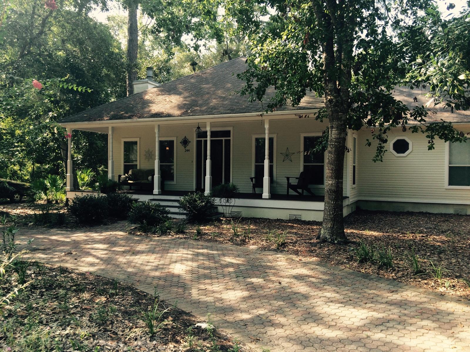 OLD FLORIDA CHARM!Three bedroom,two bath home located in quaint and beautiful Fischers Landing off Mack Bayou Rd nestled among the palmettos and moss covered oaks. You are greeted by a circular drive & spacious front porch ideal for relaxing & taking in this serenity. The home offers distinctive workmanship,evident as soon as you enter, with solid wood floors, 9 ft ceilings, crown moulding. The kitchen offers plenty of charm as well, with bead board wainscoting, granite counter tops and a cozy breakfast nook. The master suite is very spacious and features a trayed ceiling and large walk in closet, master bath with garden tub, separate walk in shower and dbl vanity. Then, hide away on the screened back porch where time just fades away, & DIRECTLY ONTO THE COMMUNITY DOCK LEADING TO THE BAY!!