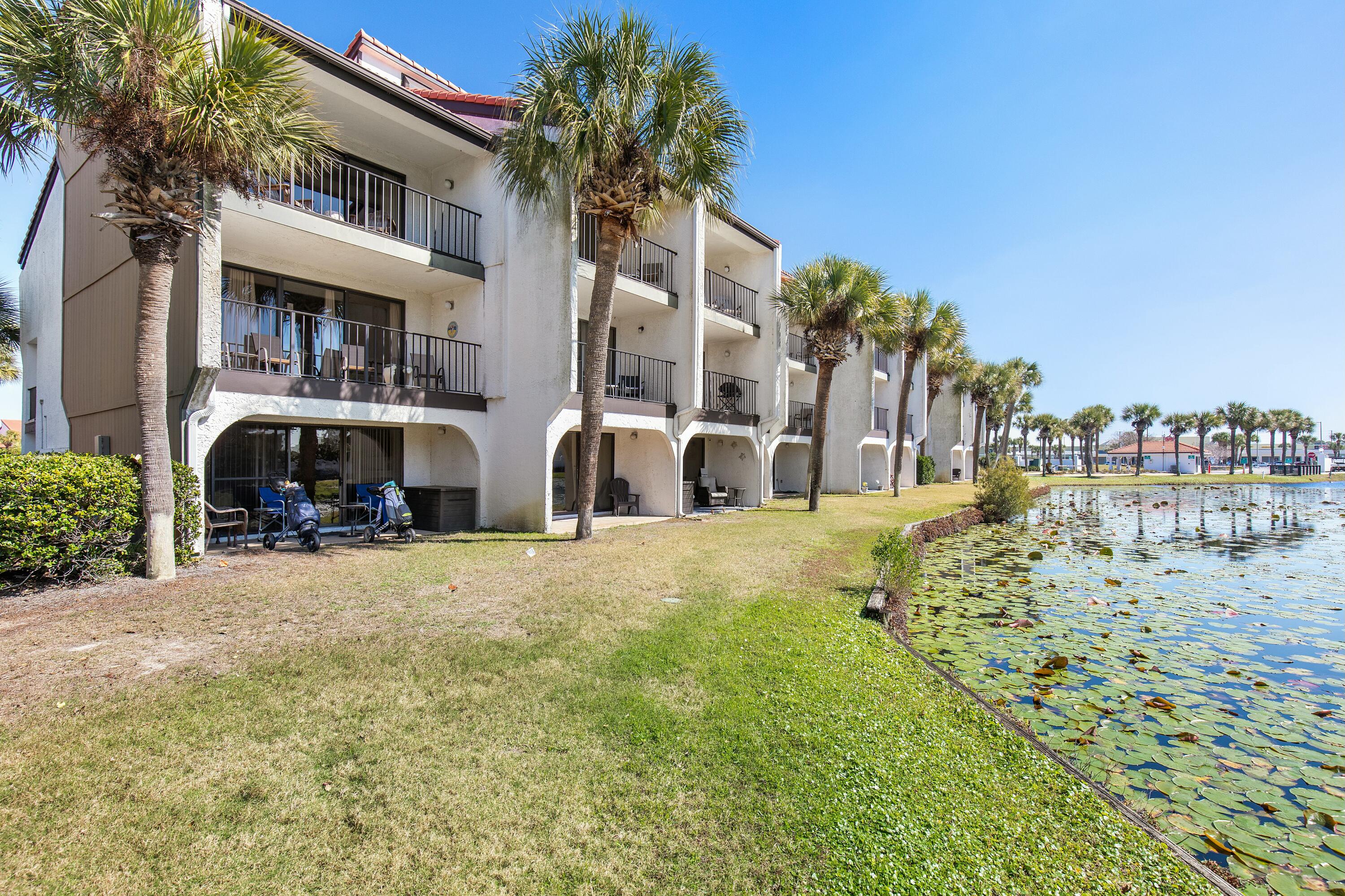 COASTAL LUXURY AWAITS - Beachside Golf Villa by the Gulf of Mexico. Welcome to your dream retreat! This stunning 2-bedroom, 2.5-bath golf villa offers 1,330 square feet of beautifully designed living space, just steps away from the Gulf of Mexico. Step onto your private deck and take in the serene beauty of the golf coarse, where a picturesque lily pond shimmers in the sunlight. This tranquil oasis is a haven for coastal birds, from graceful herons to playful egrets, creating a peaceful nature filled retreat right outside your door. Whether you're sipping your morning coffee or unwinding with a sunset drink, the soothing sounds of nature and the gentle Gulf breezes make this the perfect place to relax and recharge. Enjoy breathtaking sunset views and a resort-style lifestyle with exclusive amenities, including golf, tennis courts, multiple pools, shuffleboard, and basketball. Whether you're looking for a permanent residence, vacation getaway, or investment property, this villa offers the perfect blend of relaxation and recreation. With direct beach access and world-class golf at your doorstep, this is Gulf Coast living at its finest. Don't miss your chance to own a piece of paradise! Schedule your tour today. Seller offering $2000.00 credit to buyer at closing to replace carpet. (BUYER TO VERIFY ALL MEASUREMENTS)