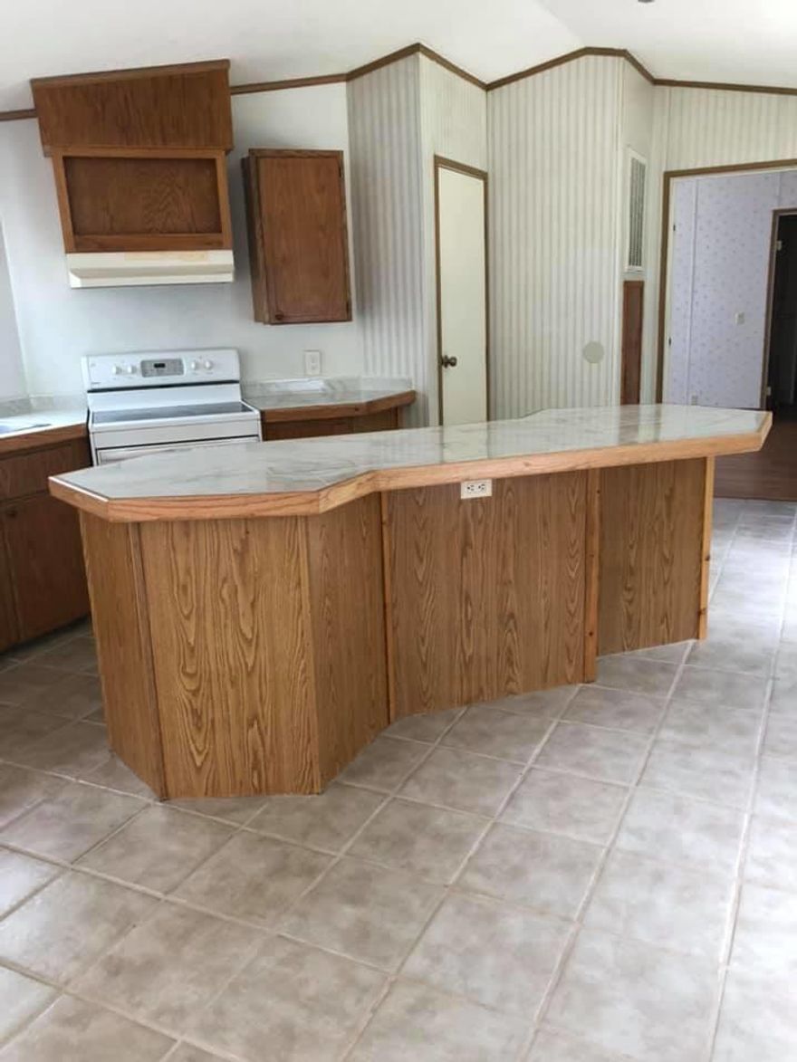 THIS is a one of a kind mobile home!! Completely remodeled with superb construction, and insulated skirting, fronts a paved road.  You have to look at all the pictures to appreciate this home, lots of NEW! New tile floors, kitchen is remodeled, private master suite from other bedrooms, all open concept. YOU can own this home.  MOVE IN READY!