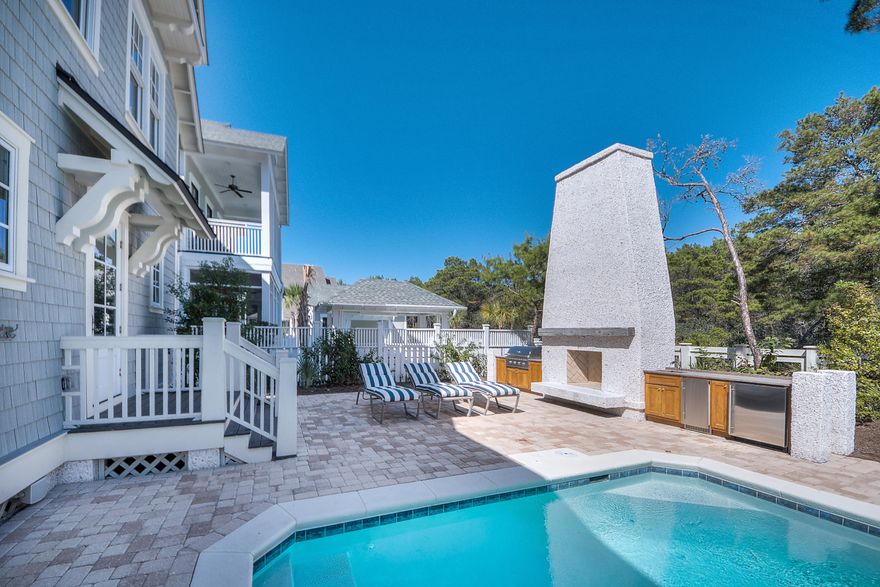 MAJOR PRICE REDUCTION!! JUST LIKE NEW! This custom designed residence in WaterSound Beach is truly amazing. The high level of finish is evident throughout the home. One immediately appreciates the wide plank white oak floors, reclaimed wood beams, Calcutta marble kitchen countertops and skillful millwork in the trim, moldings, doors and inset cabinetry. The private outside retreat is very spacious with a heated saltwater pool, stone fireplace and summer kitchen with grill, icemaker and refrigerator. Other upgrades include all marble bathrooms, Thermador appliances, custom lighting and custom made pecky cypress barn door. The open living, dining and kitchen have an abundance of natural light streaming through the windows which highlight the wide plank flooring and wood walls.