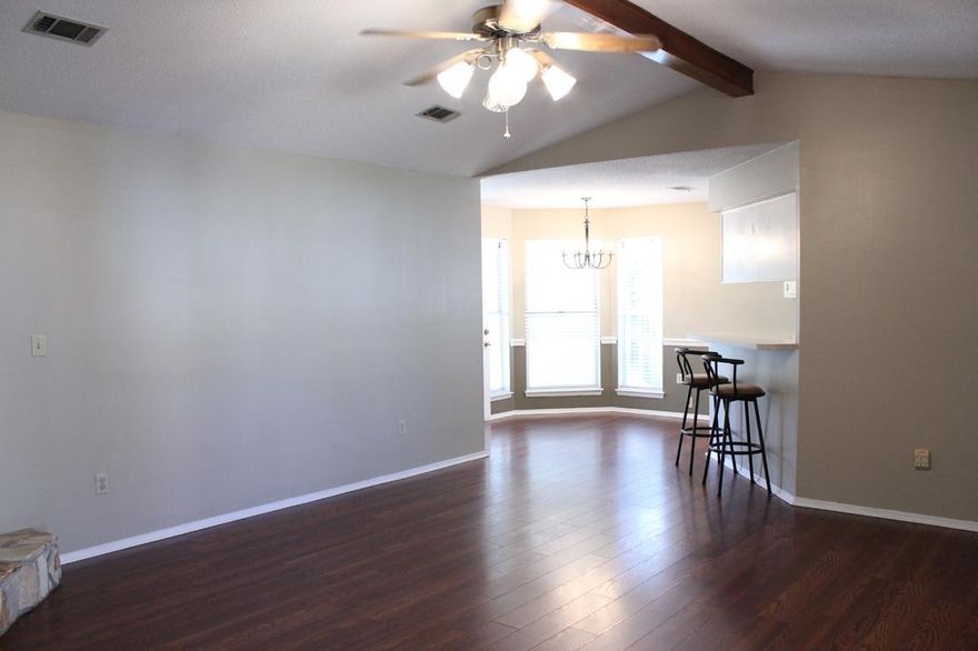 Charming 3 bedroom 2 bath home located in Blue Pine Village and just steps away from the community pools area. As you enter the home your eyes are drawn to the stone gas fireplace and beamed cathedral ceiling and beautiful laminate wood floors which flow from the living area, dining area, and into the Master bedroom. The kitchen and master bath have vinyl flooring but the remainder of the home has tile. The spacious Master suite is located just off the kitchen. The Master bath has a single vanity that is separate from the potty and stand up shower area. The remaining two bedrooms and bath are on the opposite side of the home. The enclosed patio area (heated and cooled) offers a great space for an office, exercise area, or a play area.