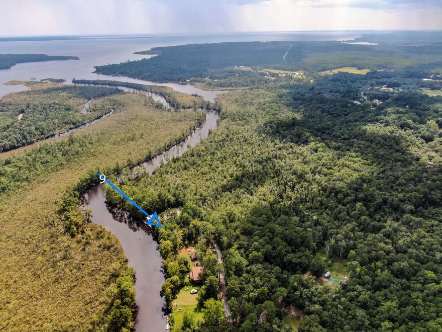 Hurry hard to find a waterfront lot on Alaqua Creek, a fresh water tributary that runs directly into Alaqua Bayou and Choctawhatchee Bay. Excellent fishing for bass, bream, shellcracker, red fish, speckled trout and flounder!  county boat ramp less than a 100 yards from subject property. Deep water.   15-18 feet deep off the dock. No  problem accessing the bay.  At the lowest point in the channel going from  bayou into the bay the depth is estimated to  be  4 feet. Adjoining W.F. lot #8 is also listed & for sale for $150,000.00