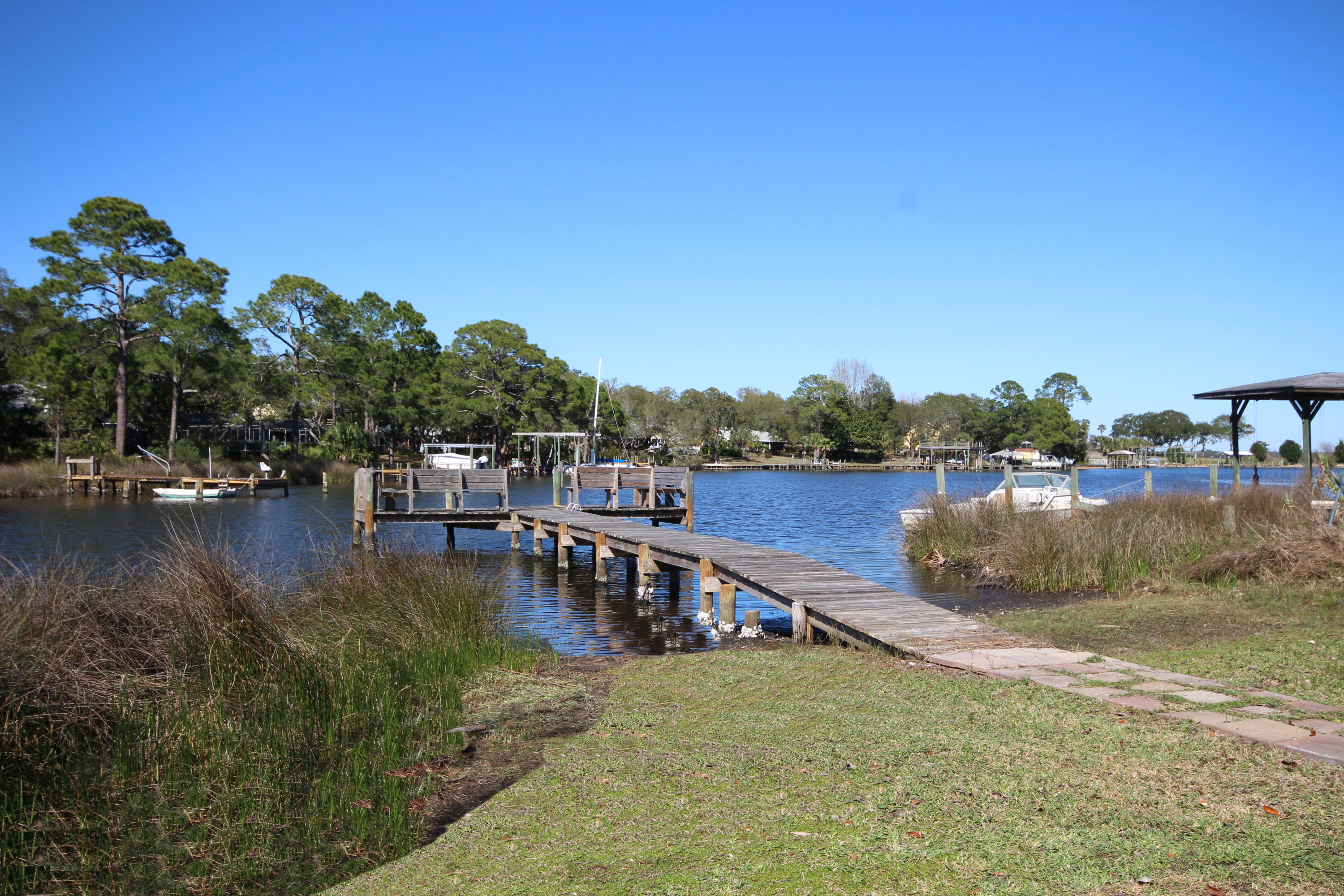 *WATERFRONT LIVING* Charming and Affordable Waterfront Home located on Lake Earl, with approximately 170 ft of waterfront and a dock that is in protected water, great for fishing or boating and directly opens to Choctawhatchee bay. Arrive via the Circular driveway with private entrance located on right of house thru gates leads you to the brick terrace where you gain access thru Front Door into theFamily Rm has brick floors, vaulted ceiling with stone fireplace. Kitchen totally renovated with NEW White Shaker Cabinets, Appliances, Granite Countertops, installed and Wood flooring. 4 bedrooms and 2.5 Baths. This home is ready for you to take it to the next level. Great neighborhood. It is a short stroll to Ferry Park, tennis courts, Elliotts Point elementary school and FWB Yacht Club.