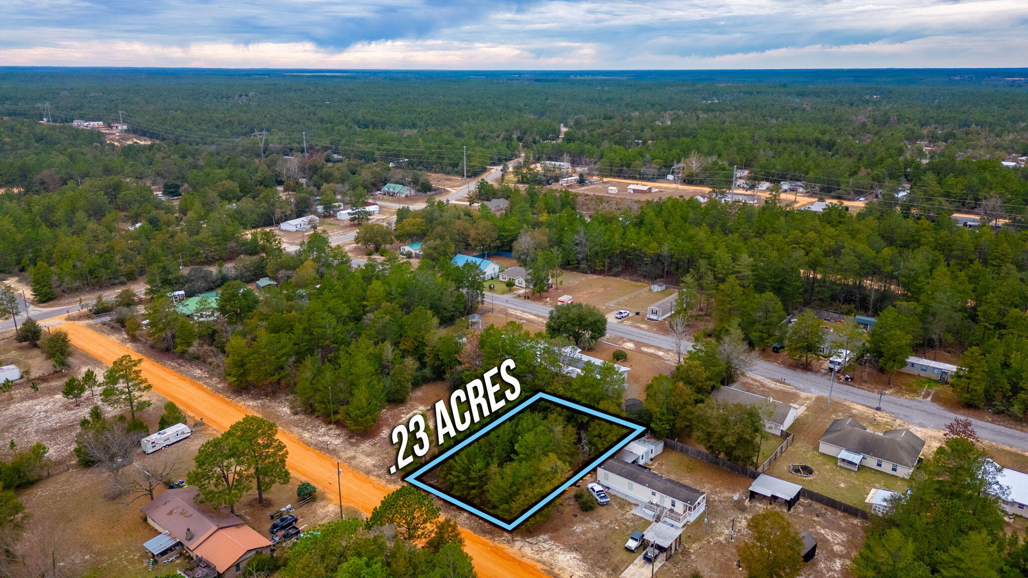 .23-acre lot in Oakwood Hills Unit I. No restrictions mean limitless possibilities against a wooded backdrop. Level, no flood, no wetlands, & recently surveyed. Manufactured homes are allowed. Power and water are at the street. The tap fee is due and a septic tank is needed. Accessible 500 ft from a paved road on a county-maintained road. Just 5 blocks off of Hwy 90. Seize this opportunity!