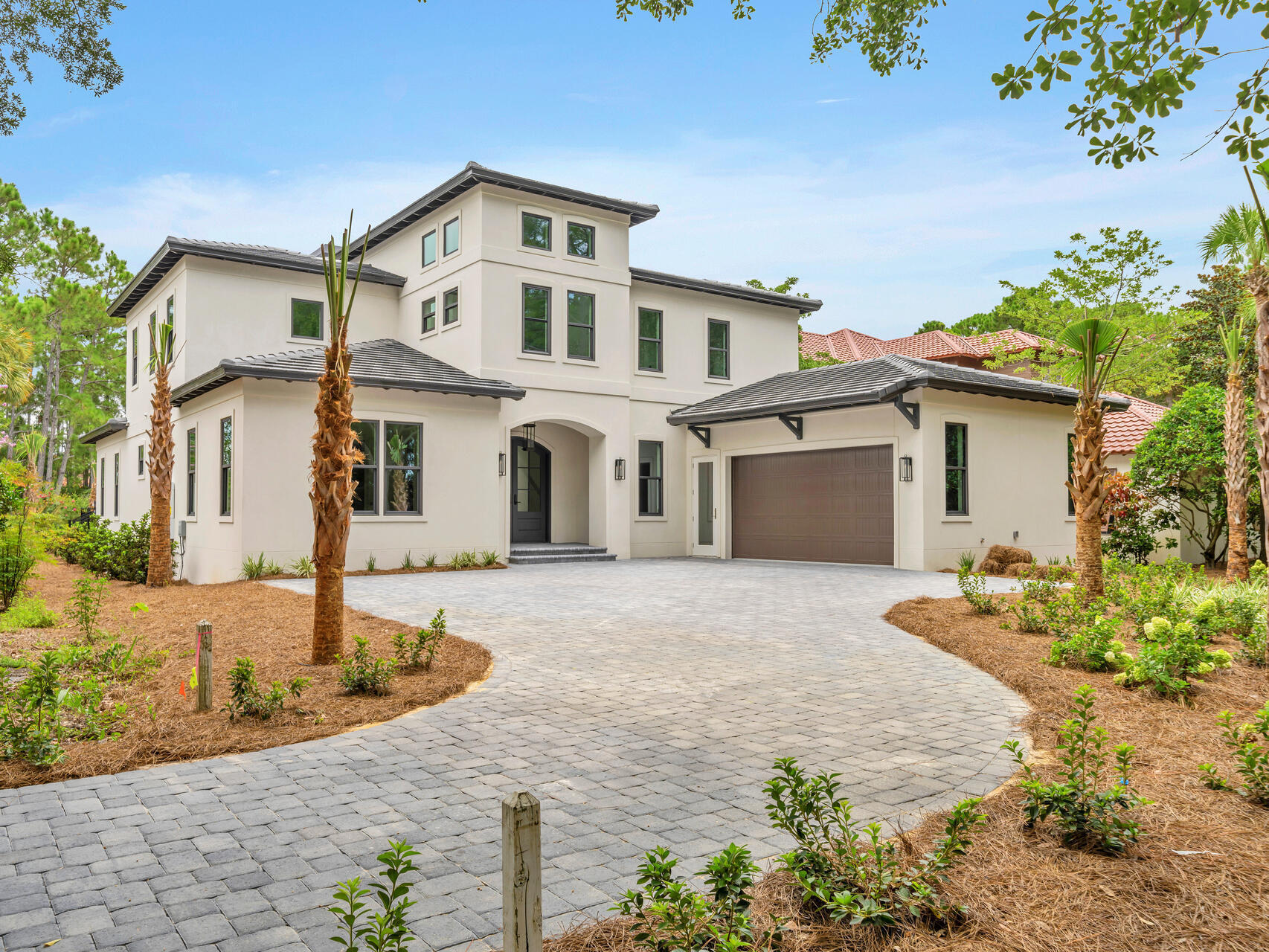 This brand-new waterfront home occupies a prime 0.27-acre lot in Del Mar at Sandestin. Another quality home built by Coastal Custom Home Building, This imposing property backs onto a serene pond offering unspoiled views from the private pool terrace. With 71 feet of water frontage and a new sea wall. At the front of the home, a sweeping driveway provides ample parking for multiple vehicles along with an oversized garage that includes space for a golf cart. There's access directly into the home through the laundry room and via a grand formal entrance into the foyer. The expansive great room is well laid out with designated spaces for living, dining and entertaining. Ten-foot ceilings and engineered hardwood flooring enhance this elegant space, providing a blank canvas for new owners to ad their mark. Multiple doors open directly onto the covered terrace and pool. It's a place to dine, relax and enjoy wonderful views of the tree-lined yard and lake. The kitchen is an inspiration for keen cooks and those who like to entertain. It has a long central island with seating, a useful butler's pantry and all-new Monogram appliances including a range with hood. Quartz countertops add a touch of understated luxury. Three first-floor bedrooms conveniently allow for living all on one level, if desired. The huge primary suite has pool and lake views along with a spa-like bathroom boasting twin vanities, a stand-alone tub and a separate shower. Two additional bedrooms are spacious and well-appointed with walk-in closets and private bathrooms. Stairs lead up to the spacious second-floor media area, which has soaring ceilings. Clerestory windows deliver abundant natural light to this bright and airy bonus space. Doors lead into a magnificent master suite with walk-in closet and a master bathroom with tub and shower. The split floor plan includes a second bedroom on this level, also with private bathroom and walk-in closet. Offering a resort lifestyle, this enviably located home is brand new and move-in ready. It features some automation along with a tankless hot water system and two A/C units. The fenced yard provides a sense of privacy and security around the in-ground pool. This is an unmissable opportunity to secure a primary or second home in an upscale neighborhood that does not permit short-term rentals. Championship golf courses, a marina, restaurants, tennis, pools and amenities are a short golf cart ride away. 4-seater golf cart conveys with the purchase of the home.