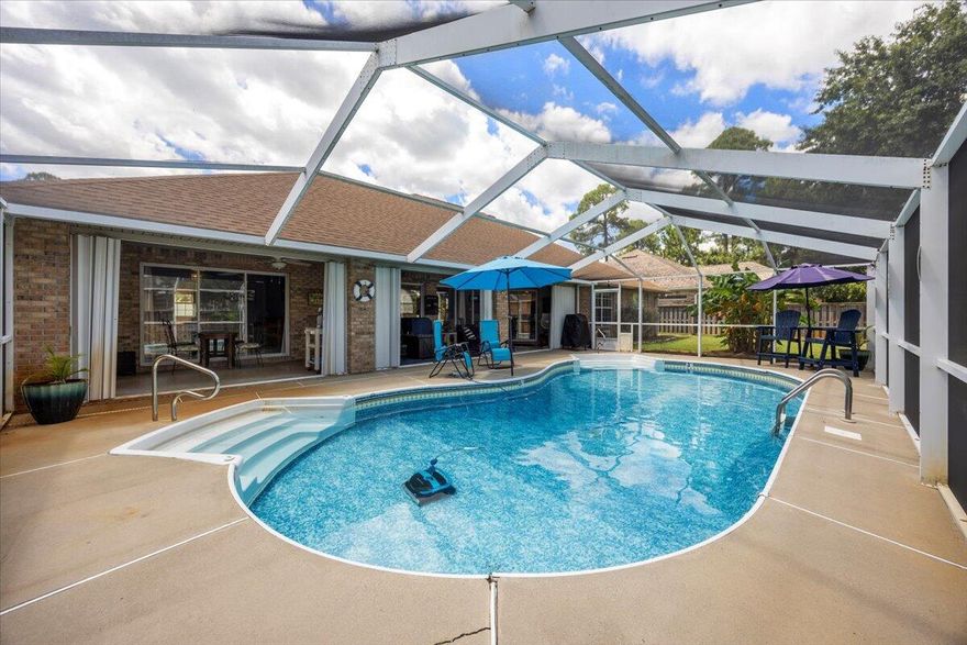 Welcome to your dream home! This beautiful 3-bedroom, 2-bath residence features a desirable split floor plan, perfect for privacy and comfort. Enjoy the luxurious screened, in-ground pool, ideal for relaxation and entertaining. The large covered patio is perfect for hosting gatherings or simply unwinding after a long day. The expansive master bedroom boasts custom closet organizers, providing ample storage. A versatile office or sitting room features a double-sided fireplace that adds warmth and charm to both the office and the open living room.The elegant dining room is illuminated by a stylish new light fixture, creating a perfect atmosphere for dinner parties. Additional features include an efficient HVAC system with an ultra-violet light, tank-less hot water heater and generator. Nestled in a charming neighborhood with sidewalks and street lamps, this home offers both beauty and functionality. A community boardwalk, provides convenient deeded access to the Santa Rosa Sound.  Don't miss your chance to make this your forever home!
