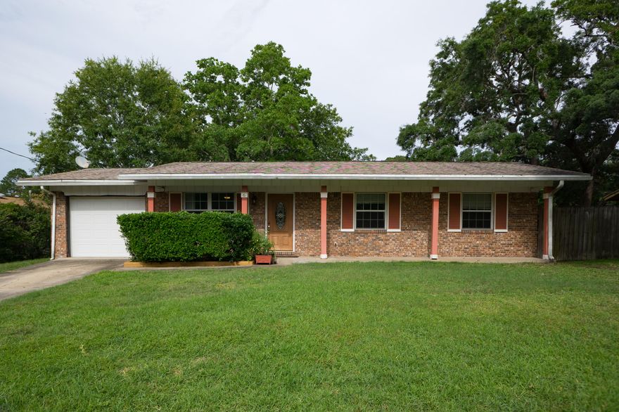 Lovely ALL brick home on a cul-de-sac is set high up on a lush yard. Excellently maintained; newly painted in cool, neutral shades. Wooden front door with beveled glass center sets the tone for quaint yet upscale. Living room leads to a dining area; track lighting and panel ceiling create ambiance. Prepare incredible meals using butcher block counter tops and the latest stainless steel features. GE freezer in the garage. Bonus room has over sized sliding glass doors overlooking the back patio; curtains match the crown molding. Large enough for a gym or your next event. Bedrooms have 12'' tile floors. Master bathroom has a marble shower with seat. The gardener in you will enjoy the outdoor compost bin, sprinkler system and pump w well. Home warranty provided for peace of mind, copper wiring