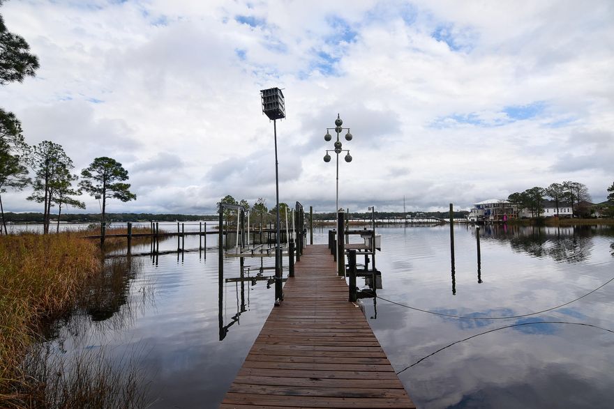This gorgeous property is located on a protected cove on Rocky Bayou. The 0.5+ acre lot boasts over 100 ft of waterfront and has a large dock with plenty of room for all of your water toys! The dock was built in 2003 and includes a 10,000 lb lift with extra pilings for additional watercraft. This 4 bedroom, 2.5 bathroom home features gorgeous hardwood flooring, vaulted ceilings, 2 fireplaces, and amazing views from most of the living areas. There is also an oversized 2 car garage and an outside basement area for extra storage. HVAC, metal roof, impact windows and doors on the back of the home (2006), paver driveway (2010), and Terminix termite bond in place.