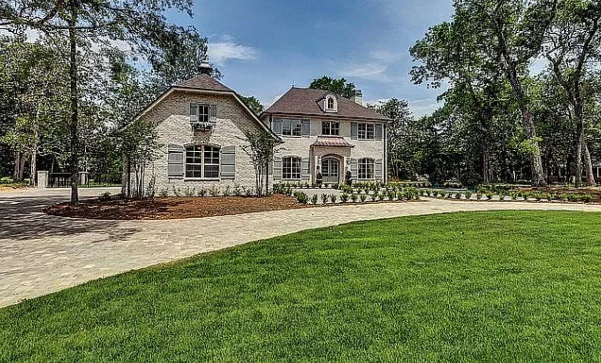 This luxurious custom craftsman home was designed with every detail in mind. Drive up to a large round about paver driveway into a colonial style entry with oversized 3 car garage. This 5 bedroom house has large cathedral ceilings with open concept living space. Huge island with farmhouse sink and Thermidor/Viking appliances. Custom Bevolo lights and chandeliers with triple crown molding throughout. The master bedroom has a through wall fireplace into bathroom with a large claw foot tub. The exterior of this brick home has a large outdoor entertainment area directly on a small lake perfect for hosting any gathering. Large yard with custom astroturf dog run a quiet neighborhood close to schools, shopping and water. Buyer to verify all dimensions, schedule a showing today!