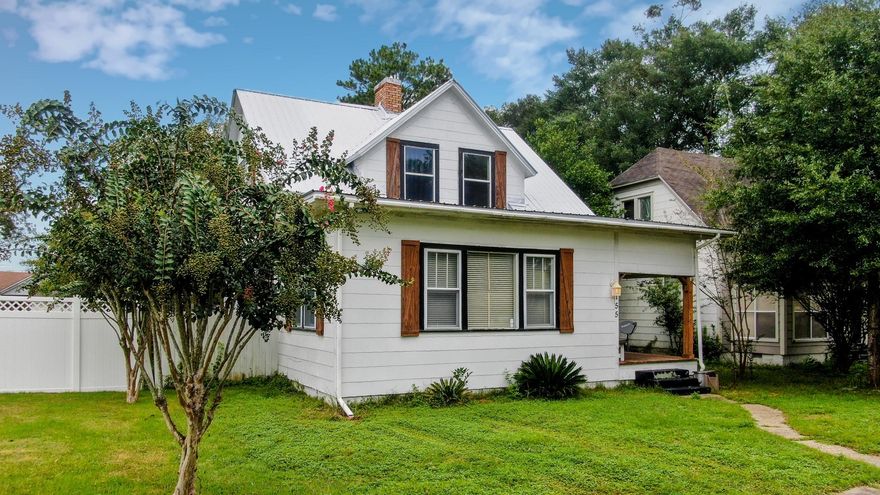 Historic charm, less than 2 blocks from Lake DeFuniak! Original pine floors, fresh interior paint and both the metal roof & HVAC have been replaced within the last 4 years. Sizable kitchen boasts farmhouse sink, island, butcher block countertops & subway tile backsplash. Charming barn door in kitchen leading to the utility room. Living room has built-in shelves and formal living (or dining/office/flex room) has original functional gas fireplace. Master suite downstairs with huge walk-in closet and updated bath with clawfoot tub & subway tile surround. Two oversized bedrooms and a full bath are upstairs, complete with tongue and groove walls and second clawfoot tub! You'll also find plenty of storage space.  Fenced back yard & includes a workshop with bathroom facilities. Come see it today!