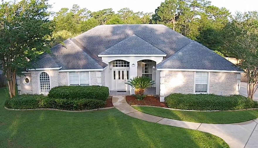 This executive, custom brick home features a beautifully balanced, open concept, split bedroom floor plan you will love. As you enter you will feel welcomed by the spacious foyer opening to the formal living and dining areas that immediately introduce you to the bespoke architectural details that make this home special. The twelve foot ceilings accented with crown molding give your mind plenty of room to wander while you read a novel by the light of the afternoon sun pouring in through the sliding glass doors overlooking your pool from the formal living room. The room also provides the volume to let your family's laughter resonate, reverberating off the hard wood floors, while enjoying a special meal in the dining room.As you move from the formal dining and livi