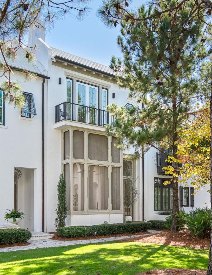 Custom-designed by Khoury Vogt Architects, this Alys Beach home overlooks the quiet greenspace of Arboleda Park and combines architectural detail with everyday livability. A two-story vaulted loggia with a wood-burning fireplace connects the private courtyard directly to the park, while bi-folding doors create a seamless indoor-outdoor flow through the main living, dining, and kitchen areas. The second floor offers three bedrooms, a bunk alcove, and multiple rooftop terraces with views of the park and the signature white rooftops of Alys Beach. Designed for both privacy and connection, the home includes a two-car garage and is ideally located between Caliza Pool, Zuma Wellness Center, and the Town Center, with convenient access to the beach via Castle Harbour Drive. Elegant design, thoughtful layout, and a rare combination of space and setting define this exceptional Alys Beach property.