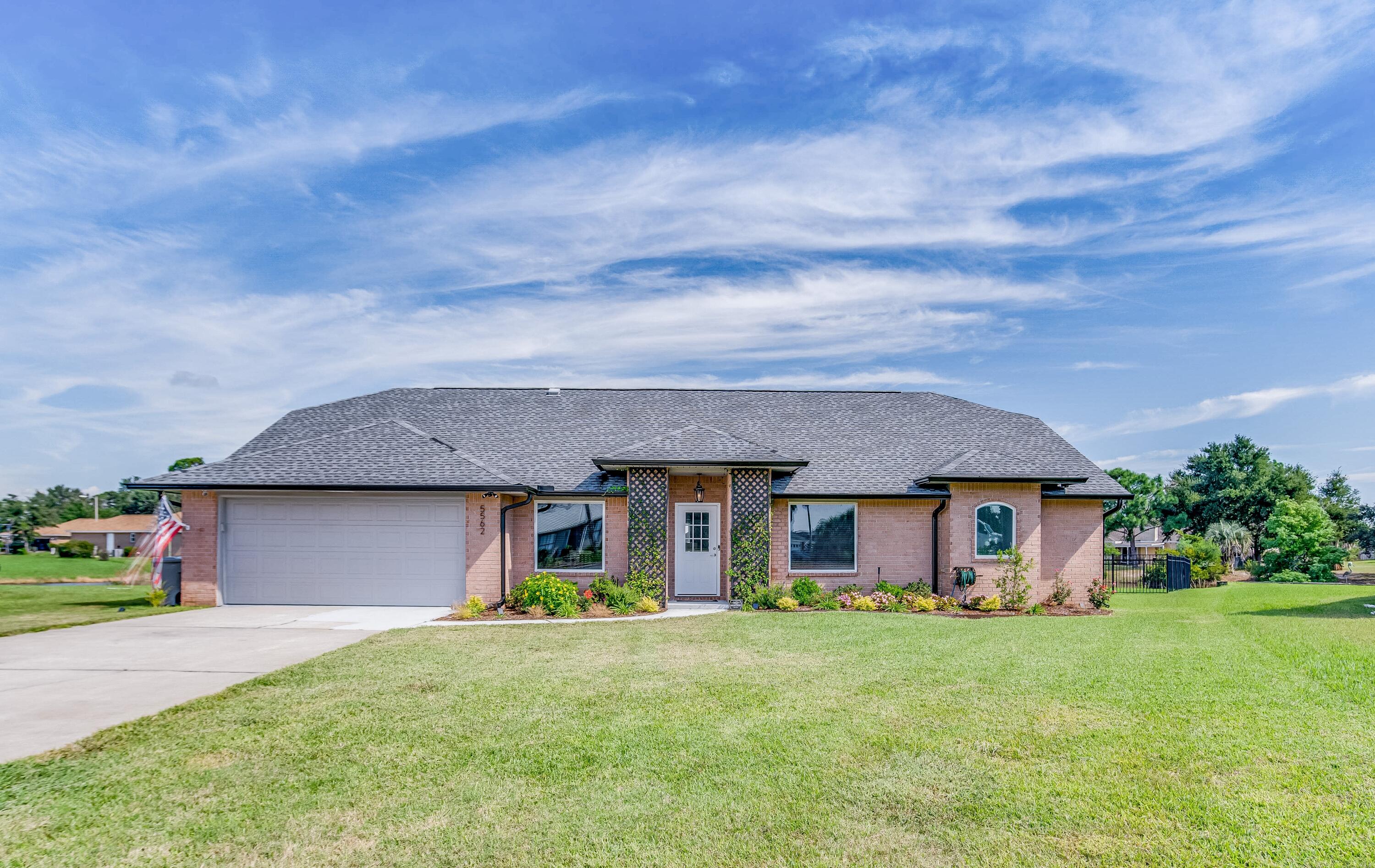 Renovated to PERFECTION! This split-plan brick home is located in the Grand Lagoon Lakes Subdivision and is a paradigm of contemporary beach living! This home offers 2,452 sqft of living space that includes 4 bedrooms/2 bathrooms, Living Room, Kitchen with kitchenette, Formal Dining Room, a multi-functional office space, Laundry Room, and a Sunroom. In addition, there is an aluminum fence giving you uninterrupted water views of the lakefront right in your backyard!