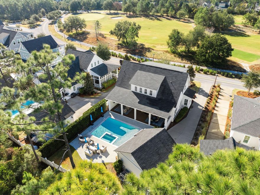 Set against a backdrop of golf course views and serene green space, this beautifully crafted four-bedroom, four-bathroom home in the coveted Watersound Origins community offers a perfect combination of luxury and privacy. Designed by Romair Construction, the residence features a large, private lot with a saltwater pool, a detached two-car garage and an expansive driveway. This property offers the rare feeling of seclusion while being just moments from the vibrant amenities of the neighborhood.  Inside, the home radiates sophistication with plantation shutters, hardwood flooring, and a spacious layout that seamlessly connects the living, dining and kitchen areas.