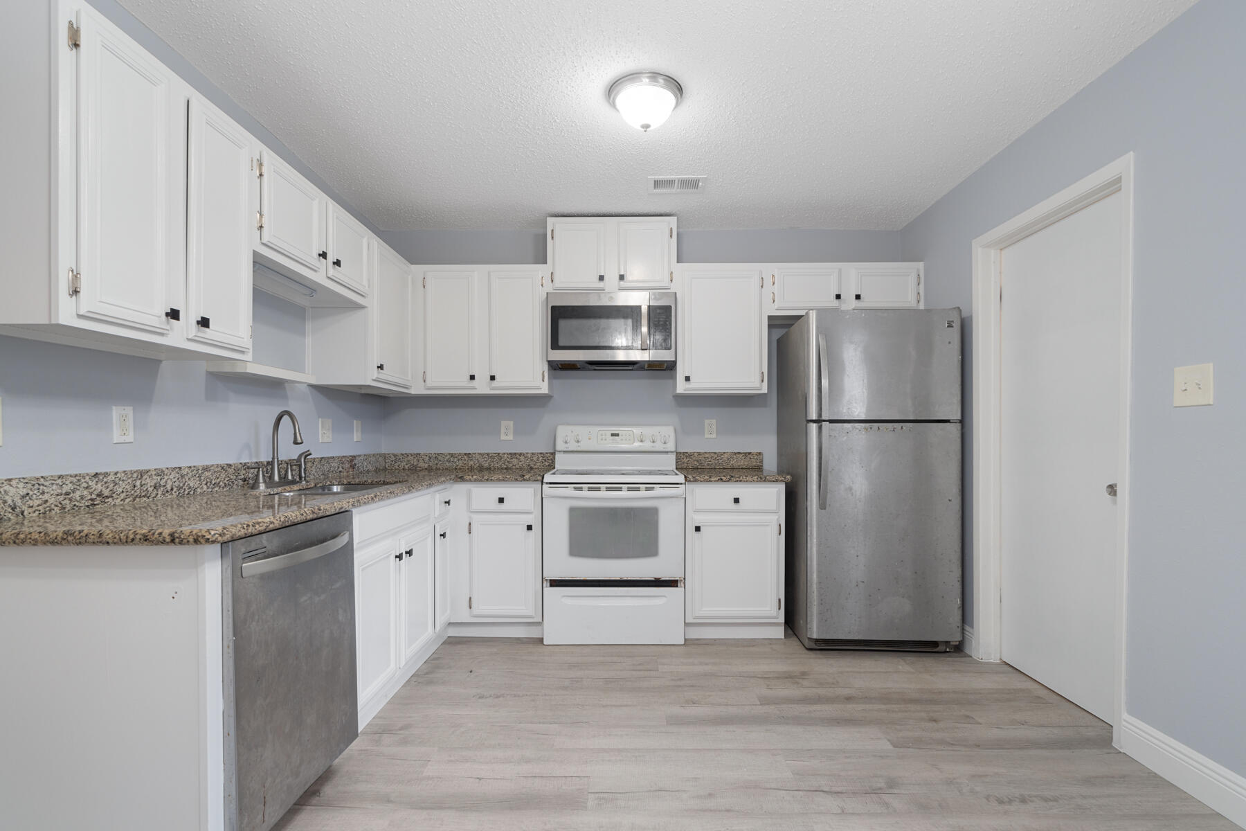 Welcome home! This charming 2 bedroom, 2 bathroom townhome in Fort Walton Beach has been newly updated and is ready for new owners. The first floor offers a large living area, a half bath and a cozy kitchen with a modern feel. The kitchen features a stainless refrigerator, dishwasher, and microwave. The granite countertops in the kitchen match with both bathroom vanities. Both bedrooms are on the second floor as well as the full bathroom. There is fresh paint and brand new LVP flooring throughout. The roof was replaced in 2022 and the HVAC in 2021. All kitchen appliances convey with the property. Schedule your showing today!