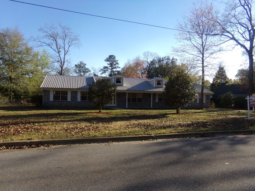 In much desired Adams Powell Subdivision, 3 Bedroom, 2 bath with formal living room & dining room~ Large famly room with fireplace that is open to the kitchen~ Large kitchen with an abundance of counter space and cabinets~ Large great room with large bonus space for storage or office area~ Detached 2 car carport with storage room, and a nice work shop in the fenced back yard~ This home is in walking distance of Bob Sikes Elementary and close to shopping~ This home is being sold AS IS~ Just needs a little TLC and you!