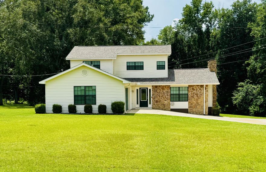 This charming two-story home offers 3 bedrooms, 2.5 bathrooms, and a spacious two-car garage. Enter a warm and inviting space featuring hardwood and tile floors, with cozy carpet in the living room. Vaulted ceilings with rustic exposed wood beams give the living area character and charm. The primary bedroom suite ensures comfort and privacy. A versatile extra room--wired with a 220 plug--is ready for your creative touch. Recent upgrades include a new roof, windows, countertops, and front door, plus fresh interior paint. The covered back porch, built in 2023, opens to a fenced area added in 2024, perfect for relaxing or backyard fun. A large powered shop on a concrete slab and an attached open shed provide added functionality and storage. The home is move-in ready.