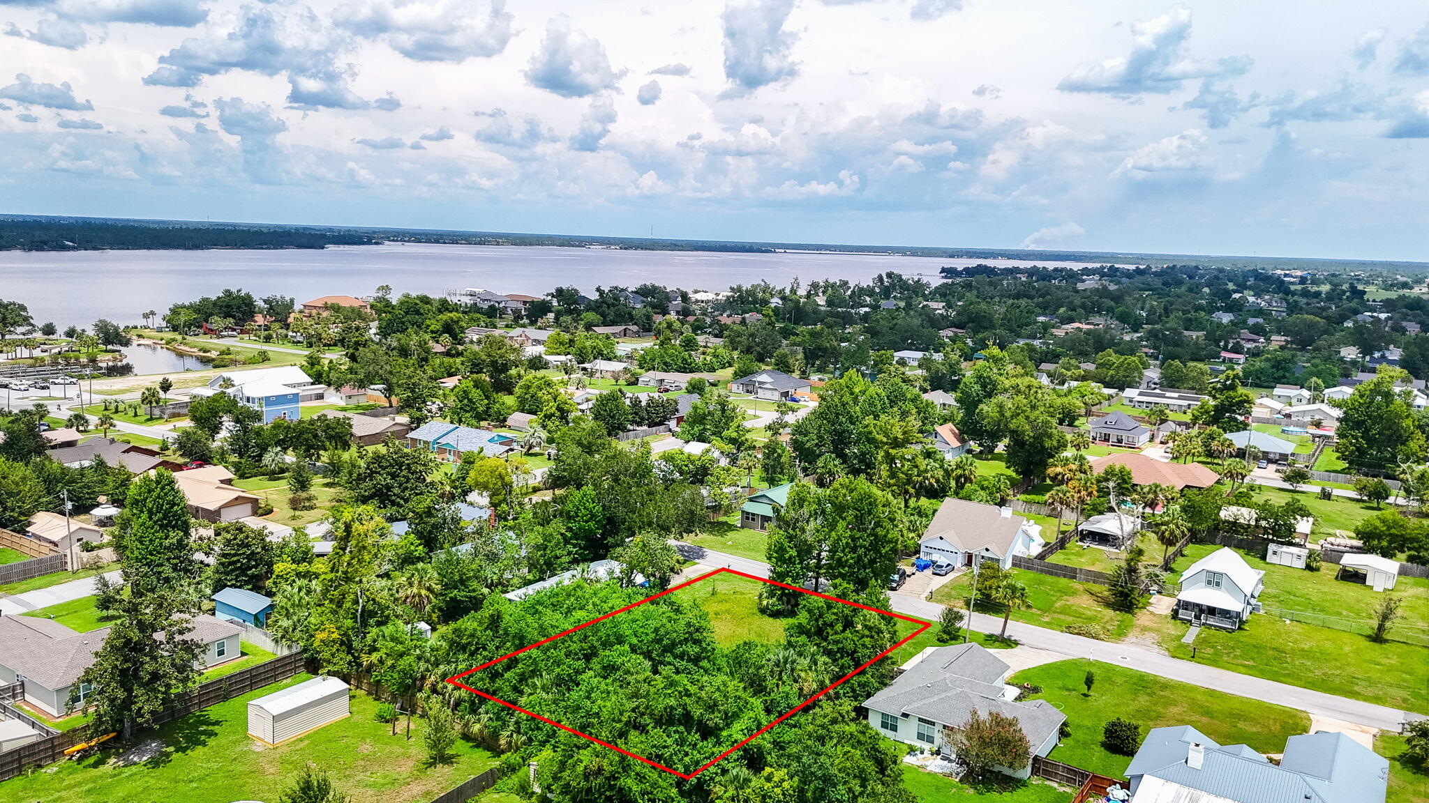Ready to build your dream home? This 100'x150' oversized homesite in the heart of Lynn Haven, Florida is walkable to the Bay and just steps from the public boat launch, waterfront park and public beach with NO HOA! Oversized, this homesite includes two parcels totaling .34 acres and is perfectly positioned in the rapidly growing and highly sought-after Lynn Haven community. Located in Flood Zone X and has a survey ready for you to begin your dream home plans. Just steps from the Bay and within walking distance to the public boat launch at Porter Park, this lot is a rare find for those who want to embrace Florida's coastal lifestyle. Bring your boat, kayaks, and water toys--there's no HOA here, so you can enjoy the freedom of living how you choose. This homesite is USDA eligible, making 100% financing a possibility for qualified buyers, and it's also compatible with FHA, VA, and conventional construction loans.
Lynn Haven offers the perfect blend of small-town charm and modern convenience. Enjoy nearby A.L. Kinsaul Park with its waterfront views, splash pad, dog park, and year-round concerts, or explore the beloved Sharron Sheffield Park, home to farmer's markets, community events, and holiday celebrations.
This homesite is also walkable to local favorite restaurants like Simply Seafood and PoFolks as well as a convenient Ace Hardware just a few blocks away. Voted one of the top places to live in Florida in 2024, Lynn Haven is a true hidden gem - families, investors, or anyone looking to build in a welcoming, walkable waterfront community.
Location is everything! Don't miss your chance to create something special in this incredible location!